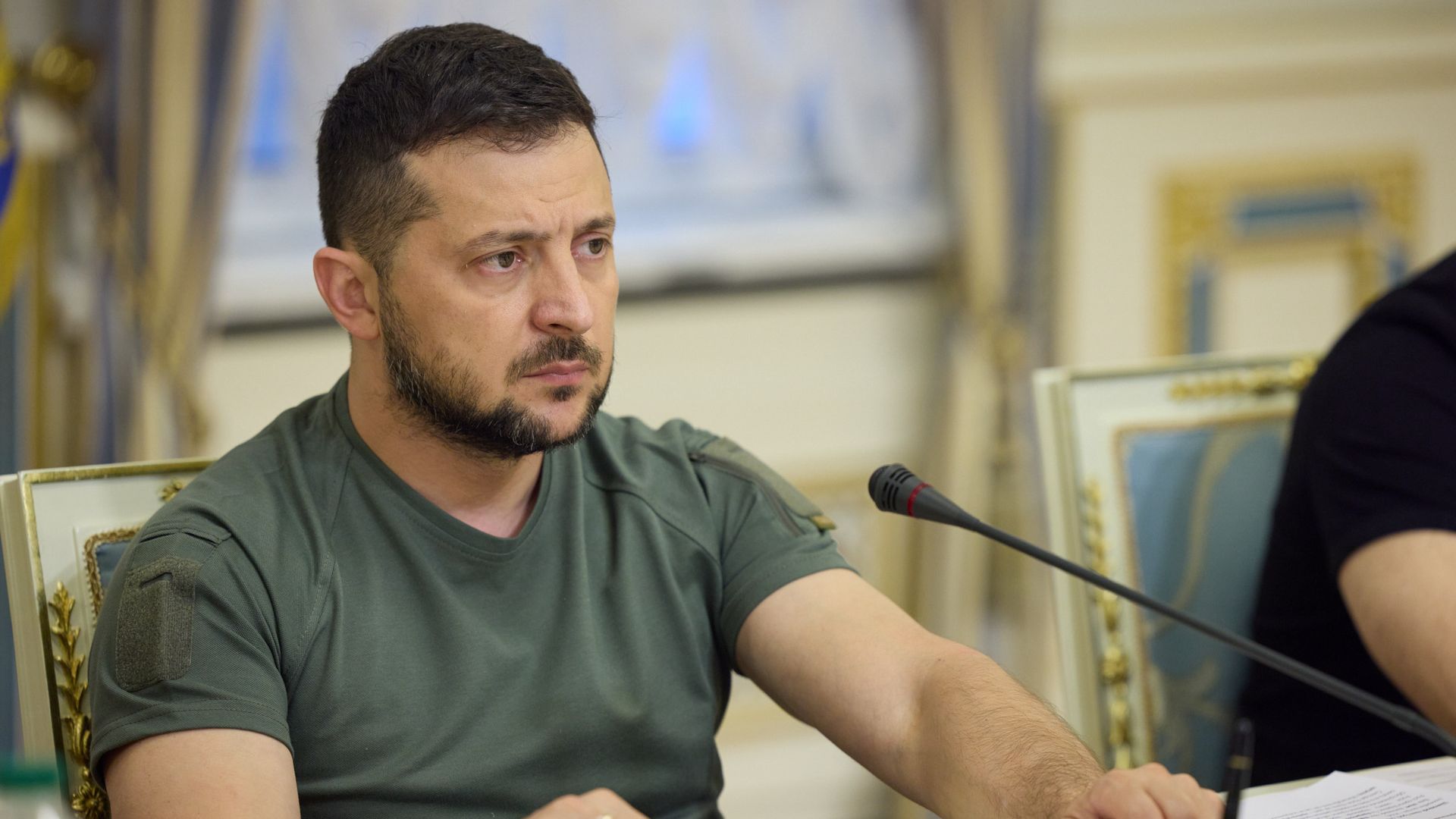 Photo of Volodymyr Zelensky sitting and looking in front of him