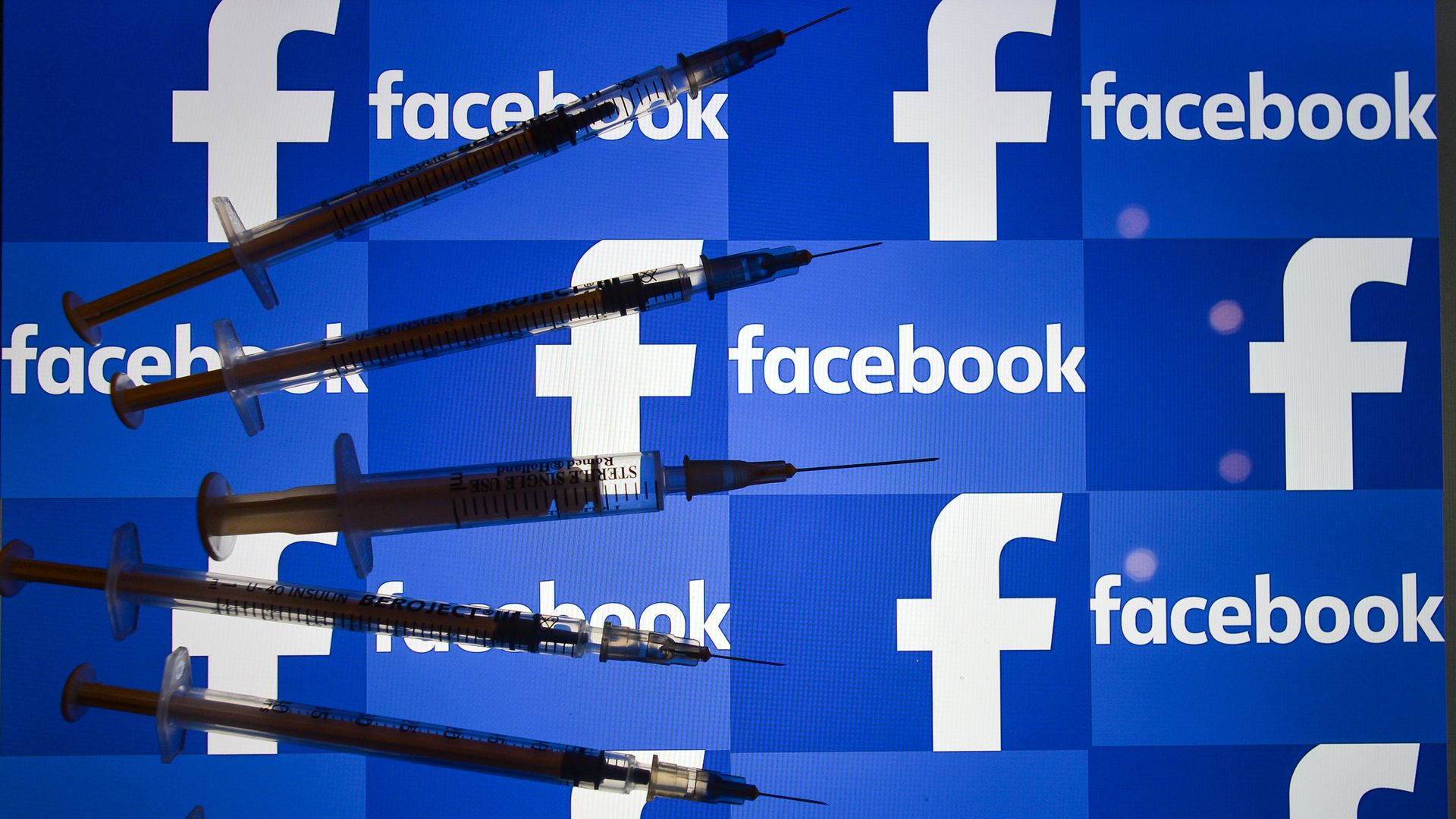 Photo illustration of a Facebook logo with syringes.
