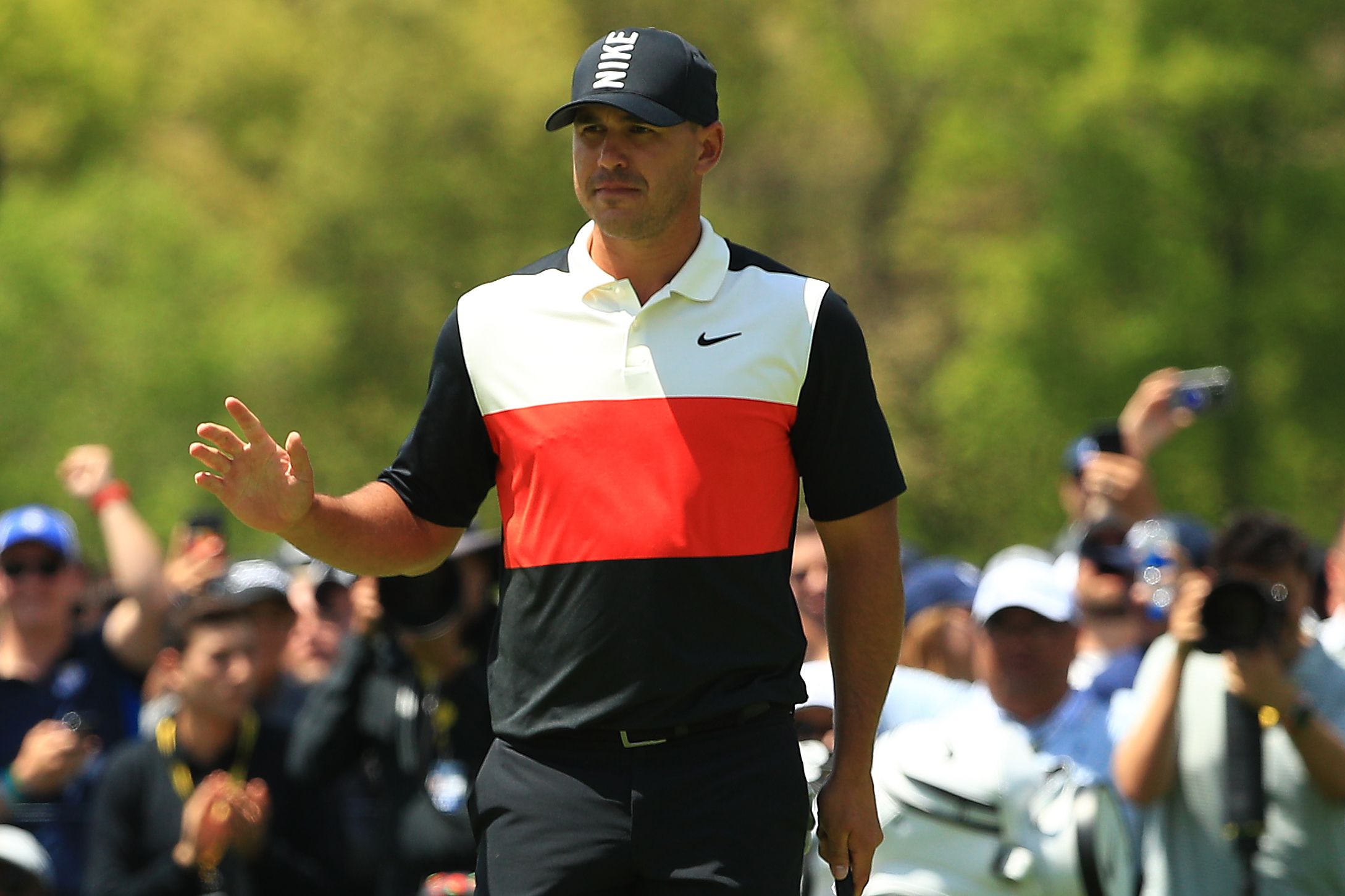 Brooks Koepka waves to the crowd
