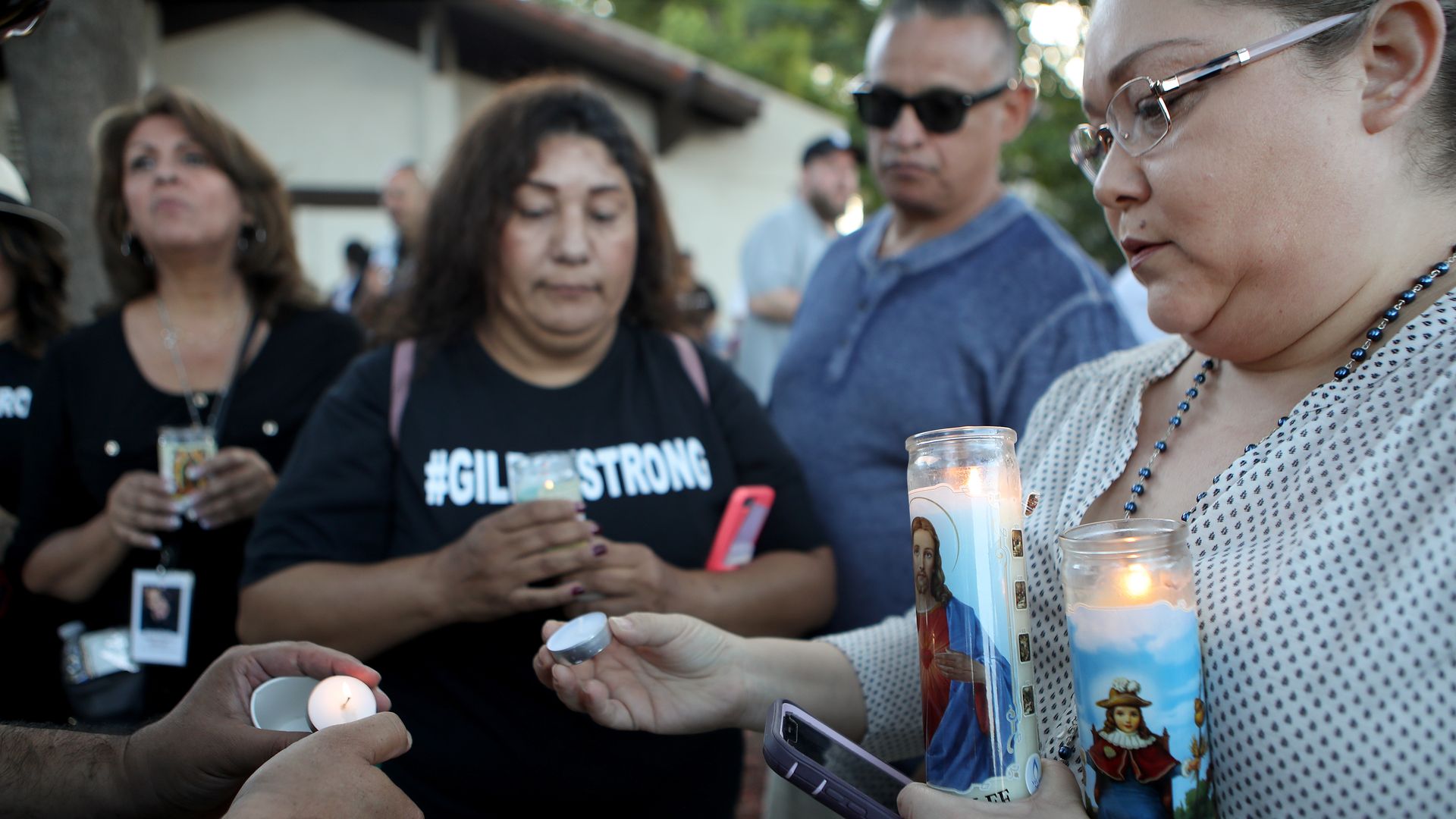  People attend a vigil for victims of the mass shooting at the Gilroy Garlic Festival on July 29.