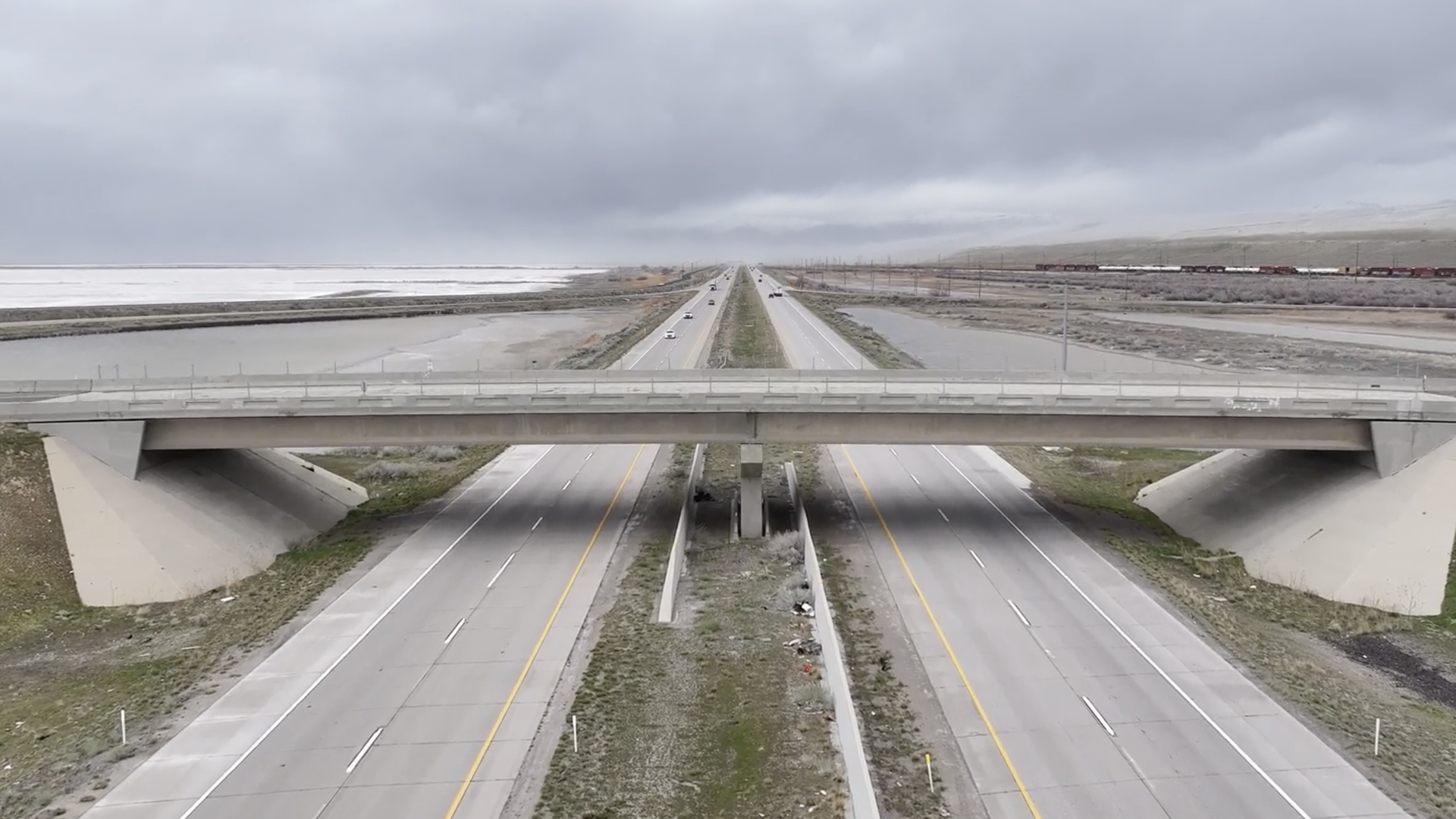 A bridge over a highway on an overcast day
