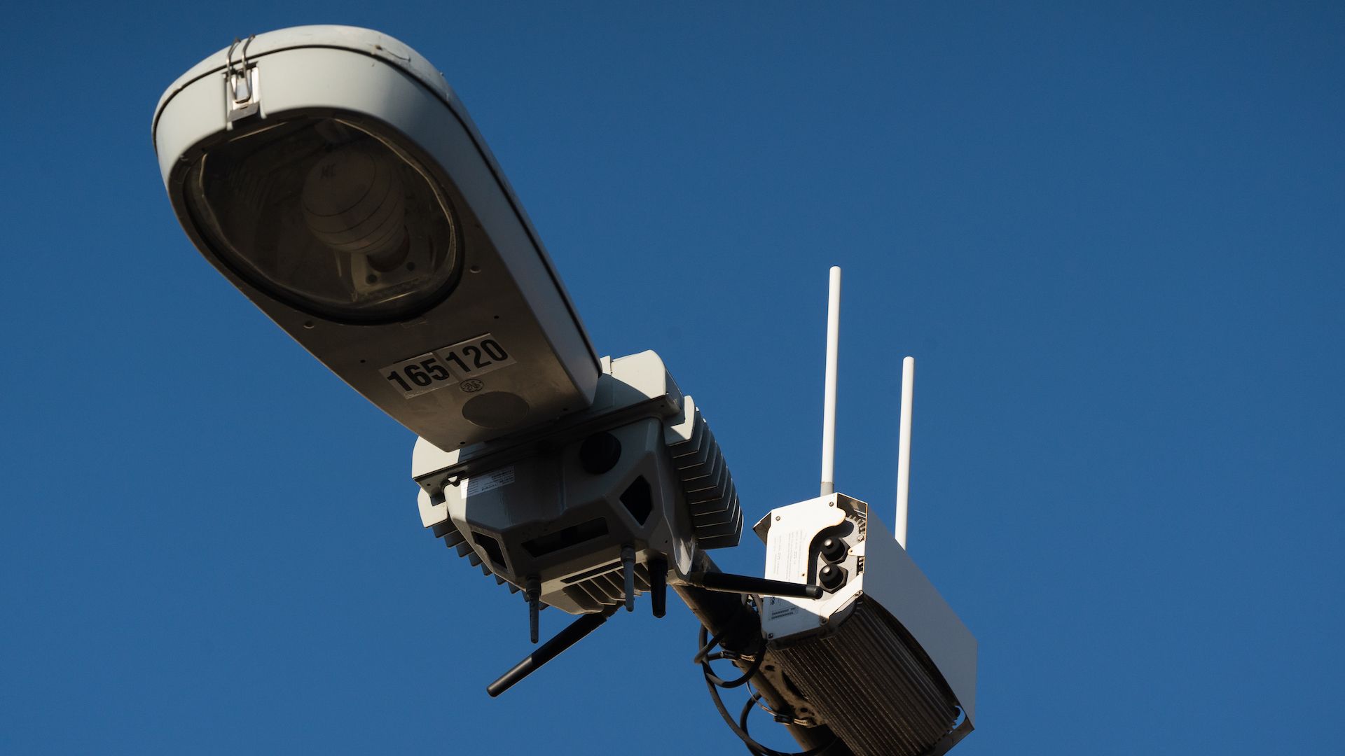 A streetlight with a surveillance camera. 