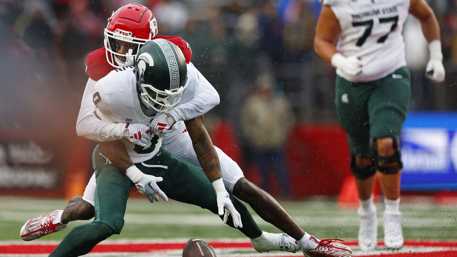 A player grabbing another player who has the ball.