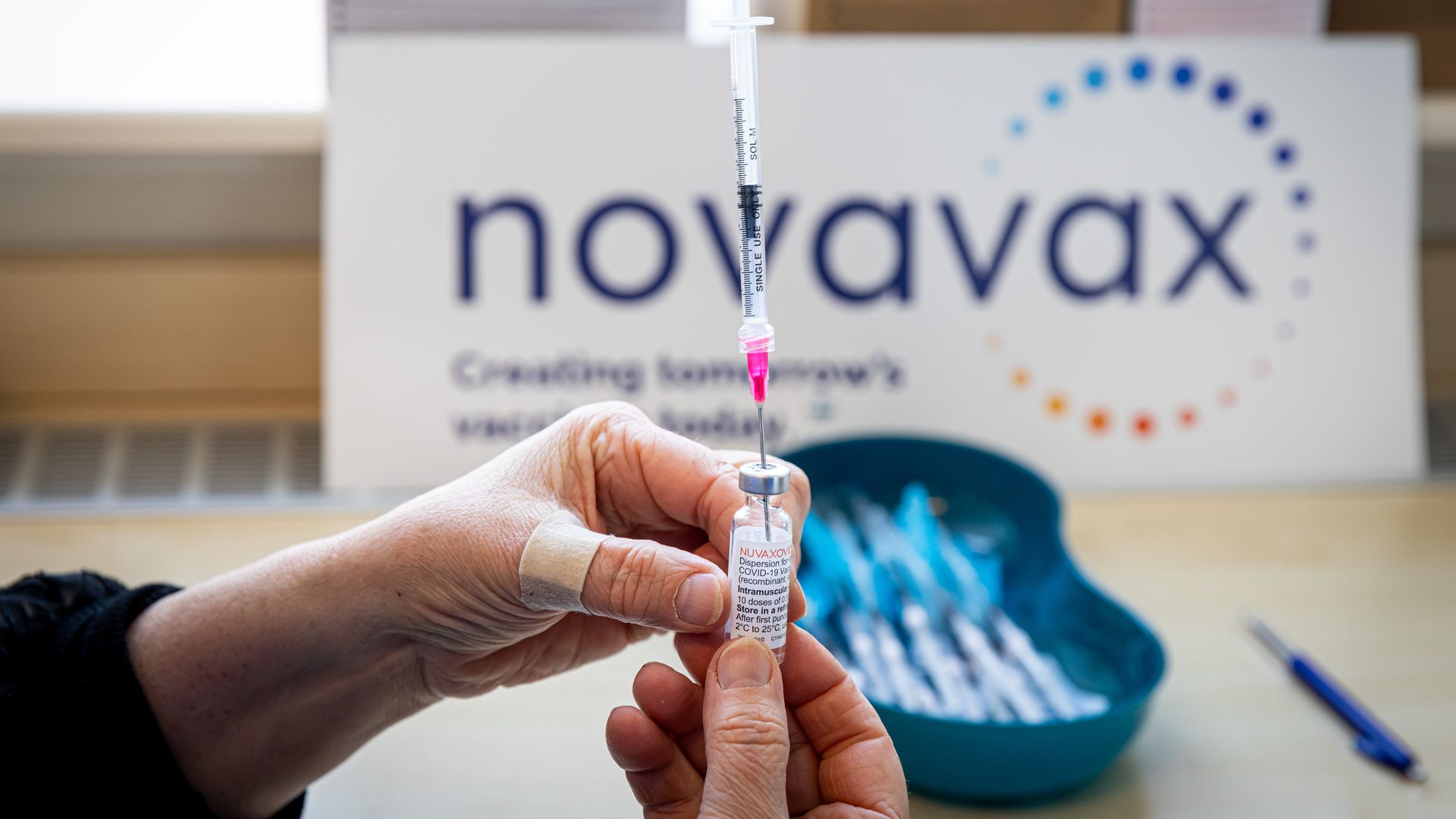 Picture of hands holding a Novavax vaccine