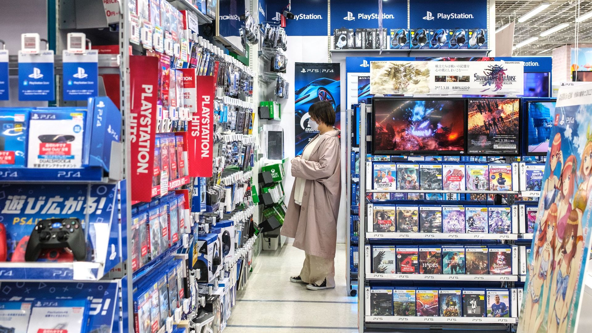 A customer shopping for games in Tokyo in May. 