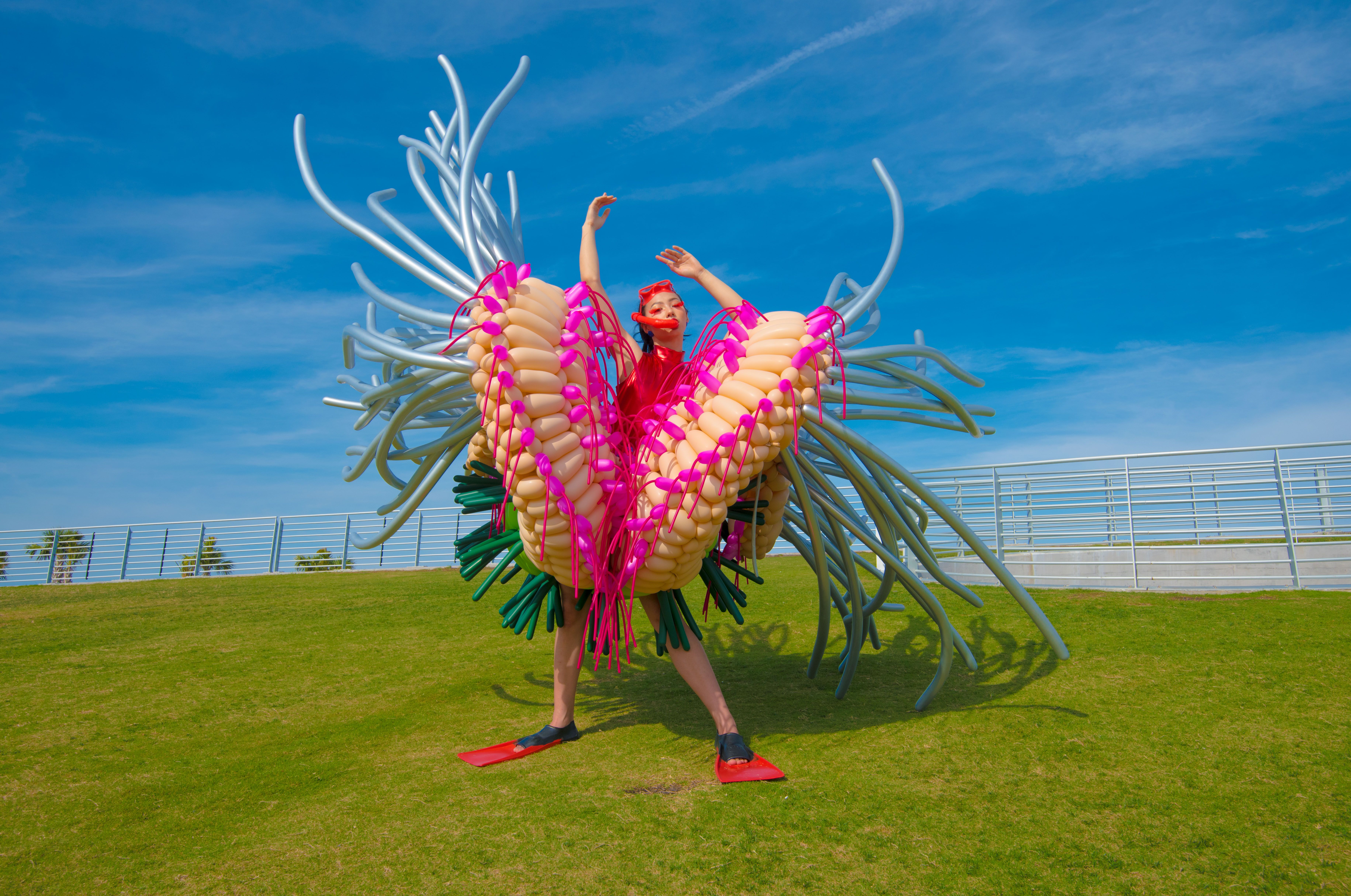 Woman covered in latex balloons to look like a sea anemone 