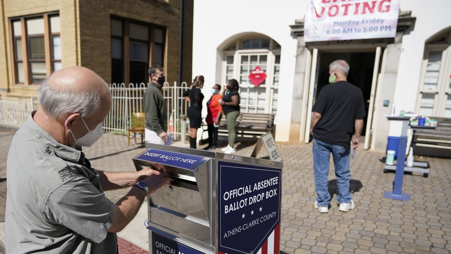 Voter casts ballot in dropbox
