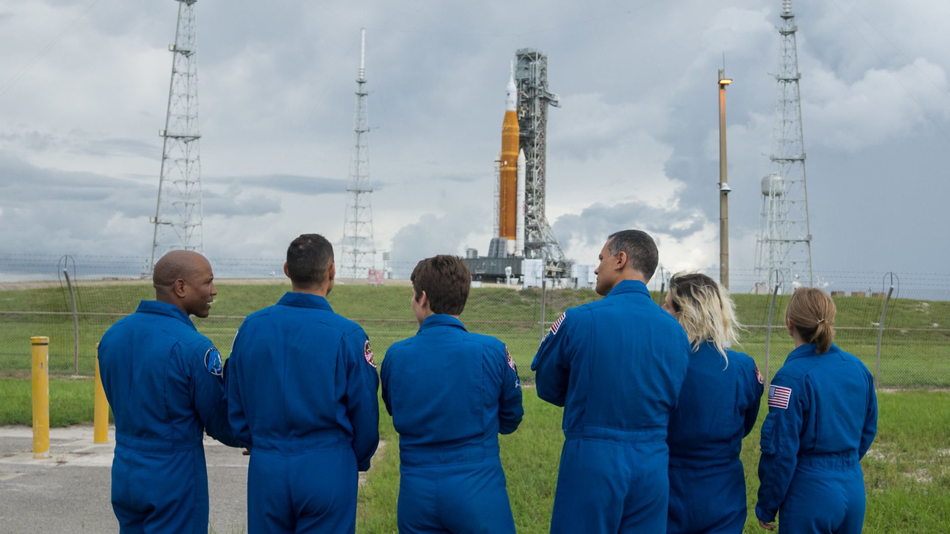 A group of astronauts checks out the Space Launch System rocket