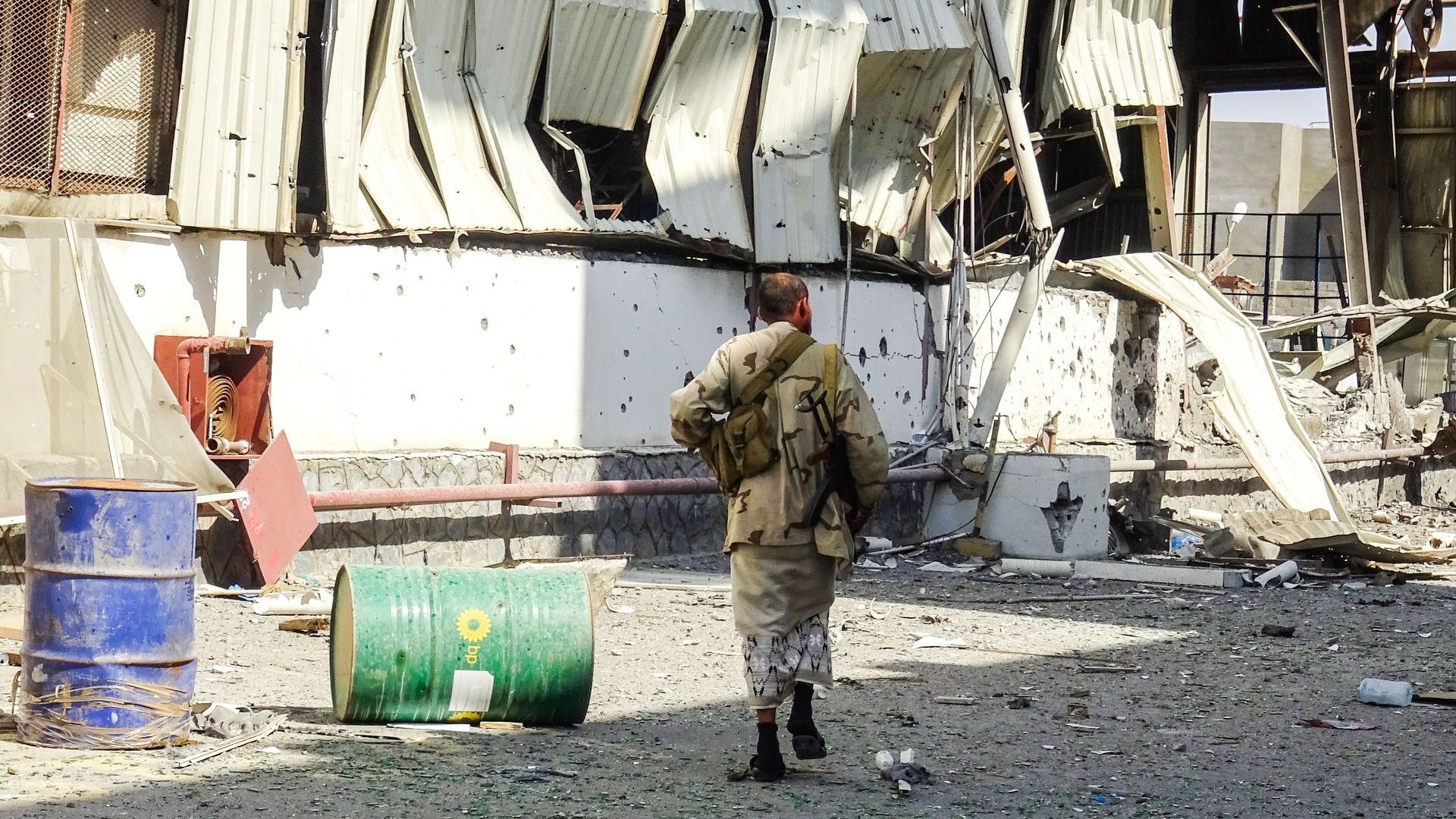 a soldier in a ravaged street of Hodeidah, Yemen