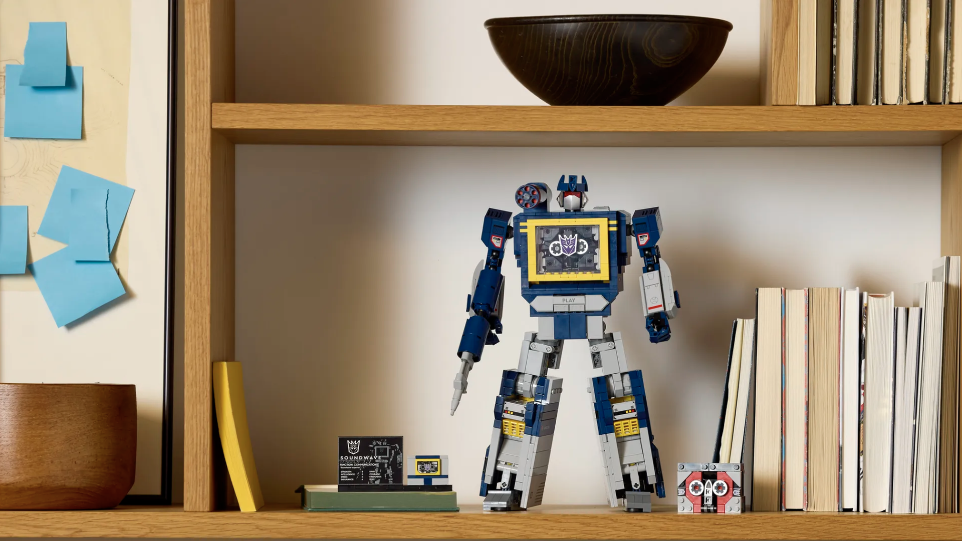 Photo of a Lego Tranformer figure standing on a bookshelf