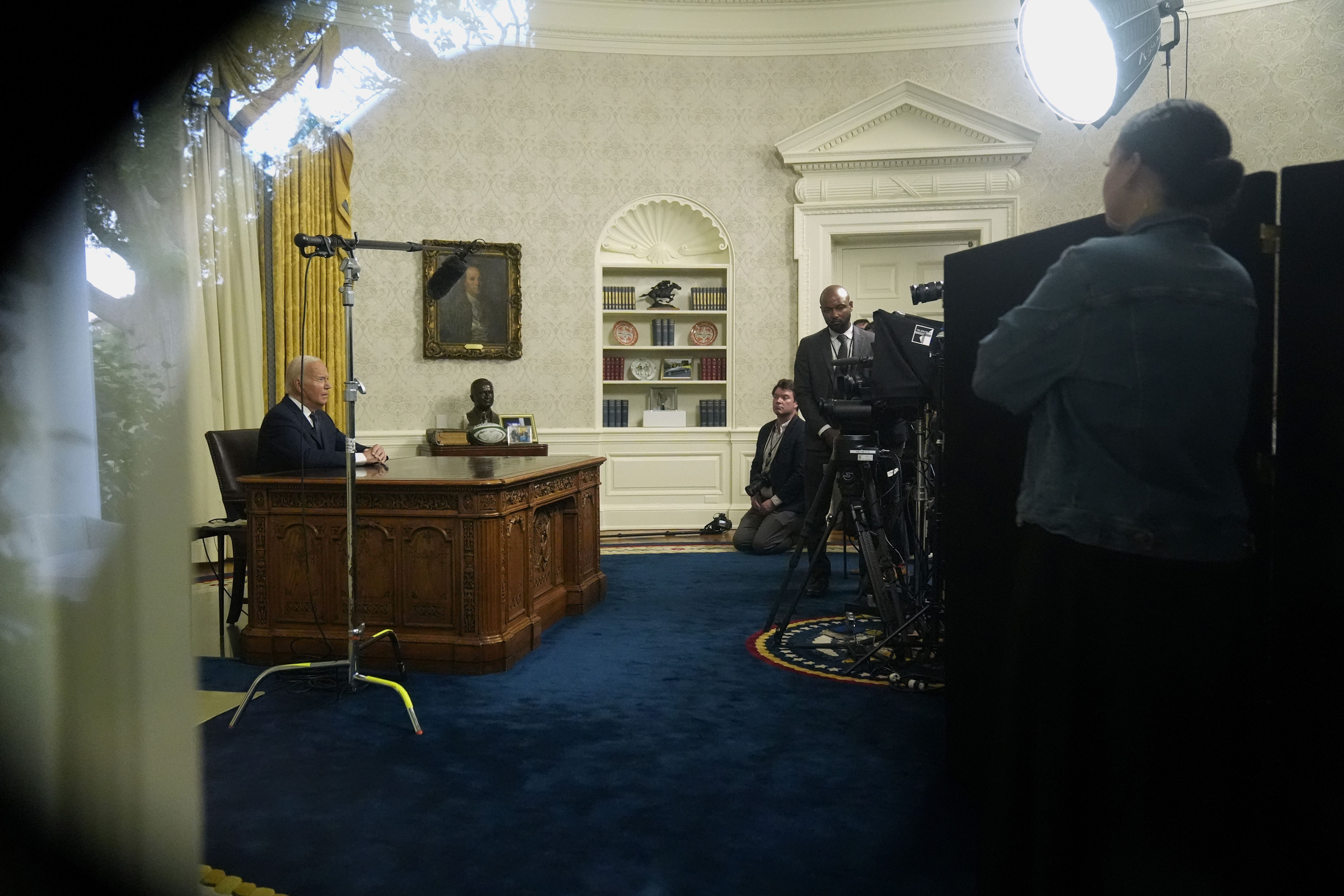As seen from a window from the Colonnade outside the Oval Office, President Joe Biden addresses the nation on the assassination attempt on former President Donald Trump, at the White House in Washington, Sunday.