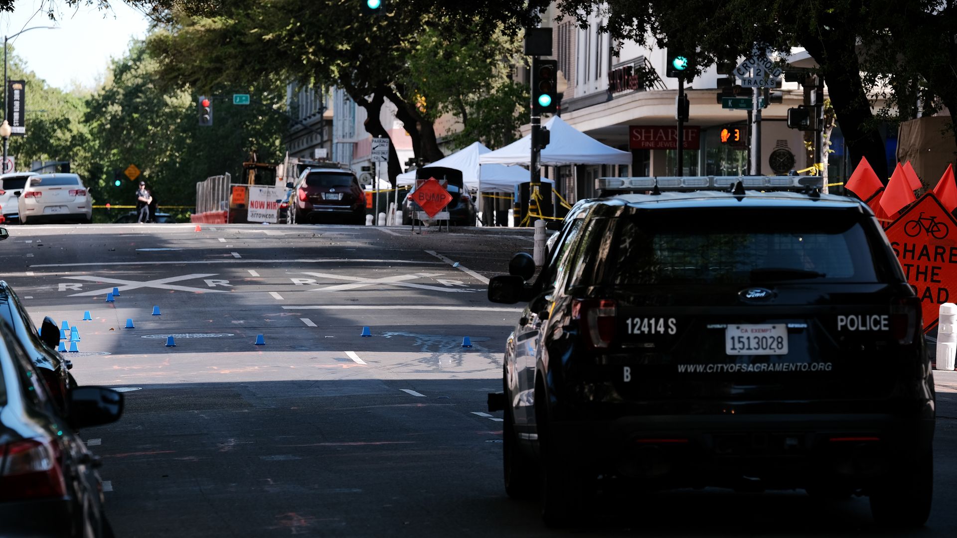 Sacramento police markers are placed in the street on the corner of 10th and L street at the scene of a shooting 