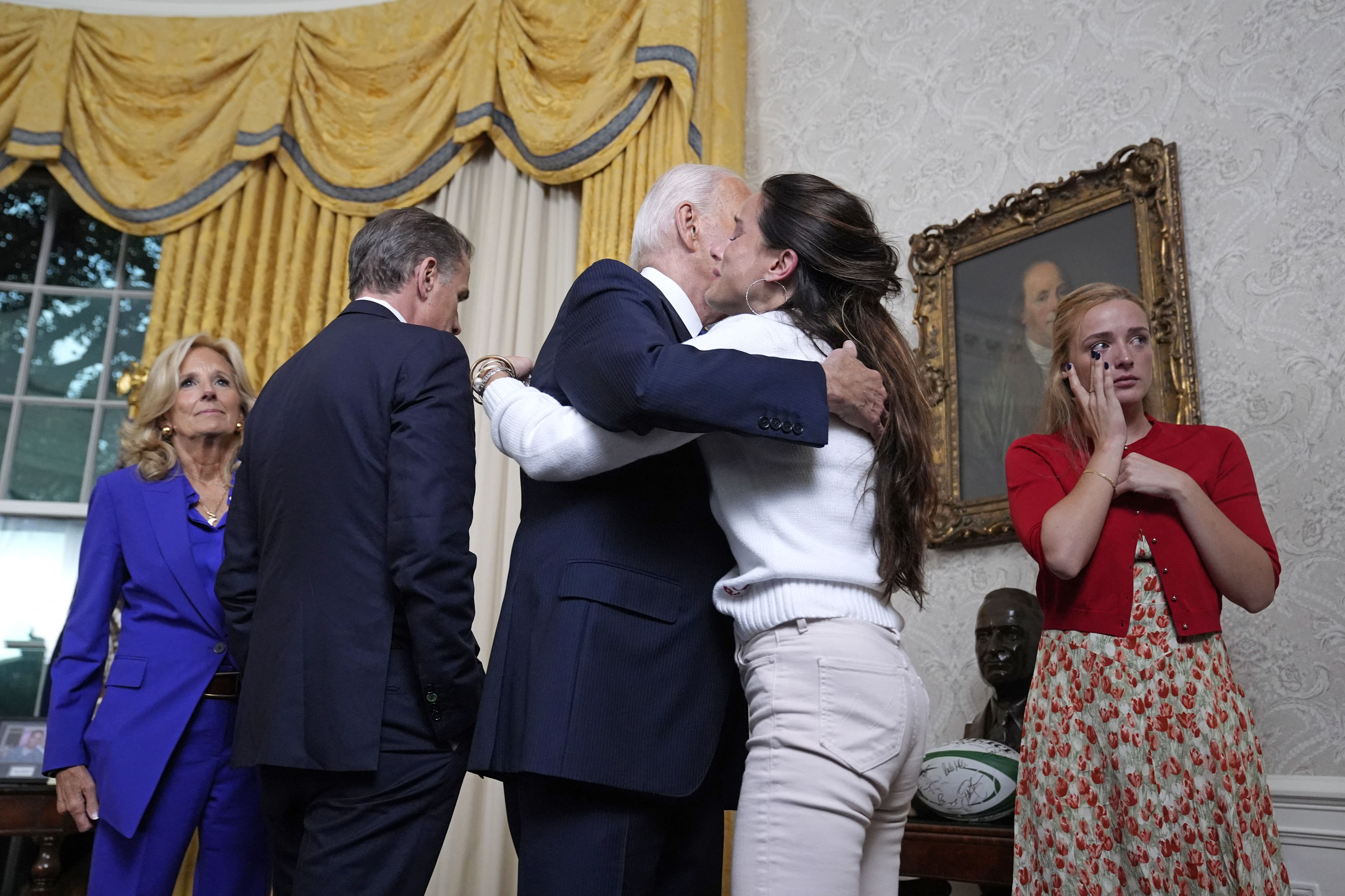 TOPSHOT - US President Joe Biden (C) hugs his daughter Ashley Biden (2nd R)