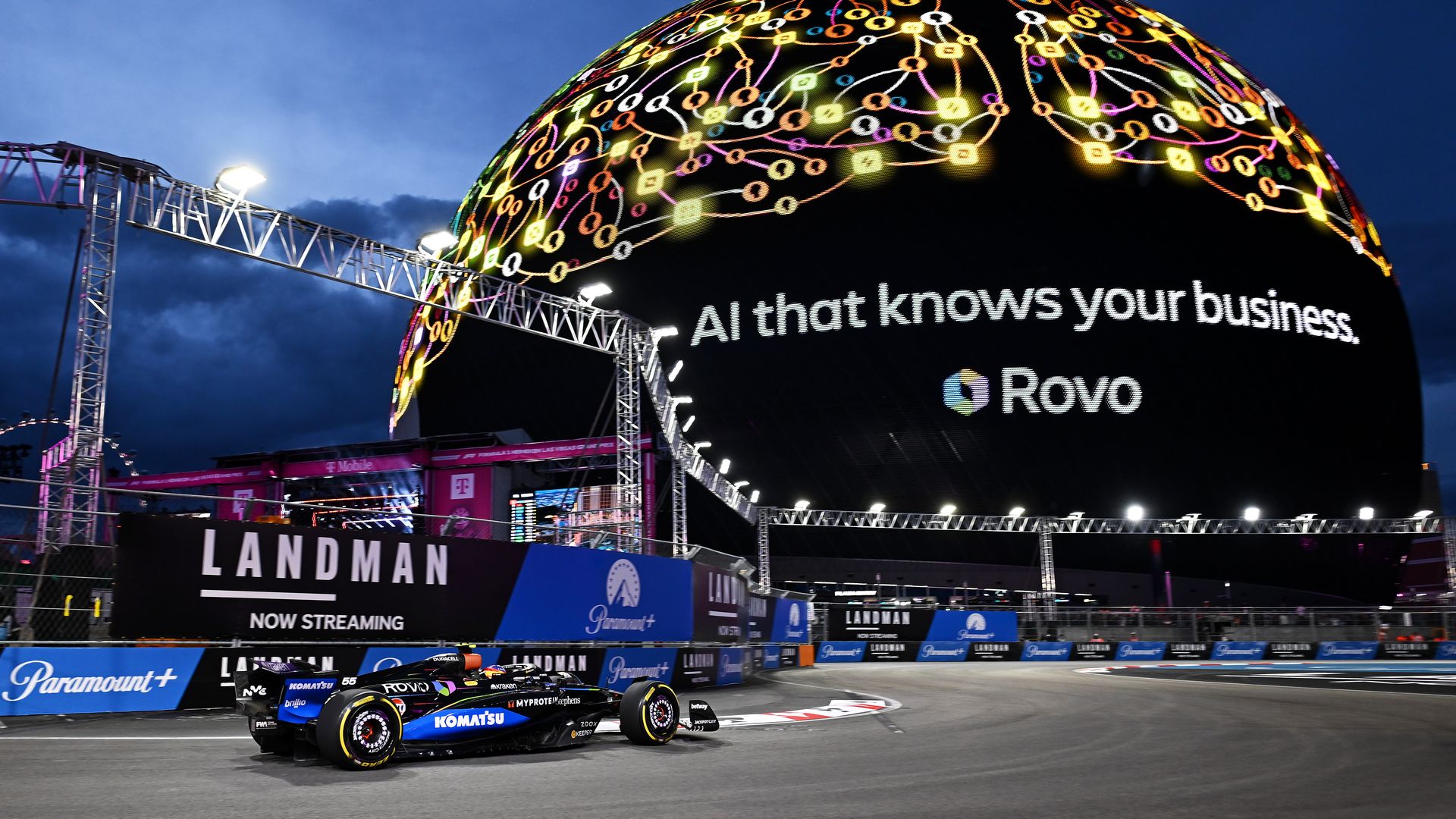 A F1 race car in front of the sphere.