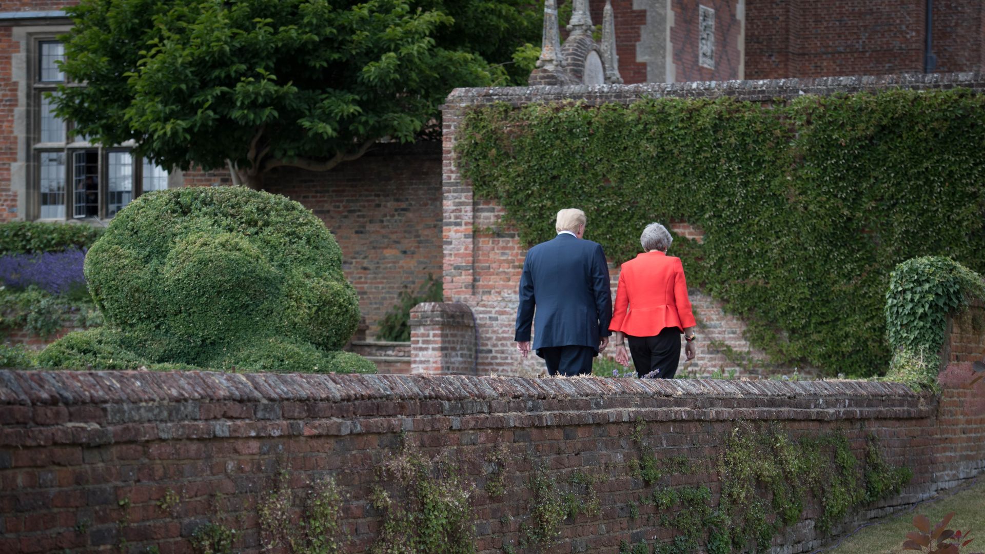 Donald Trump and Theresa May walking together 