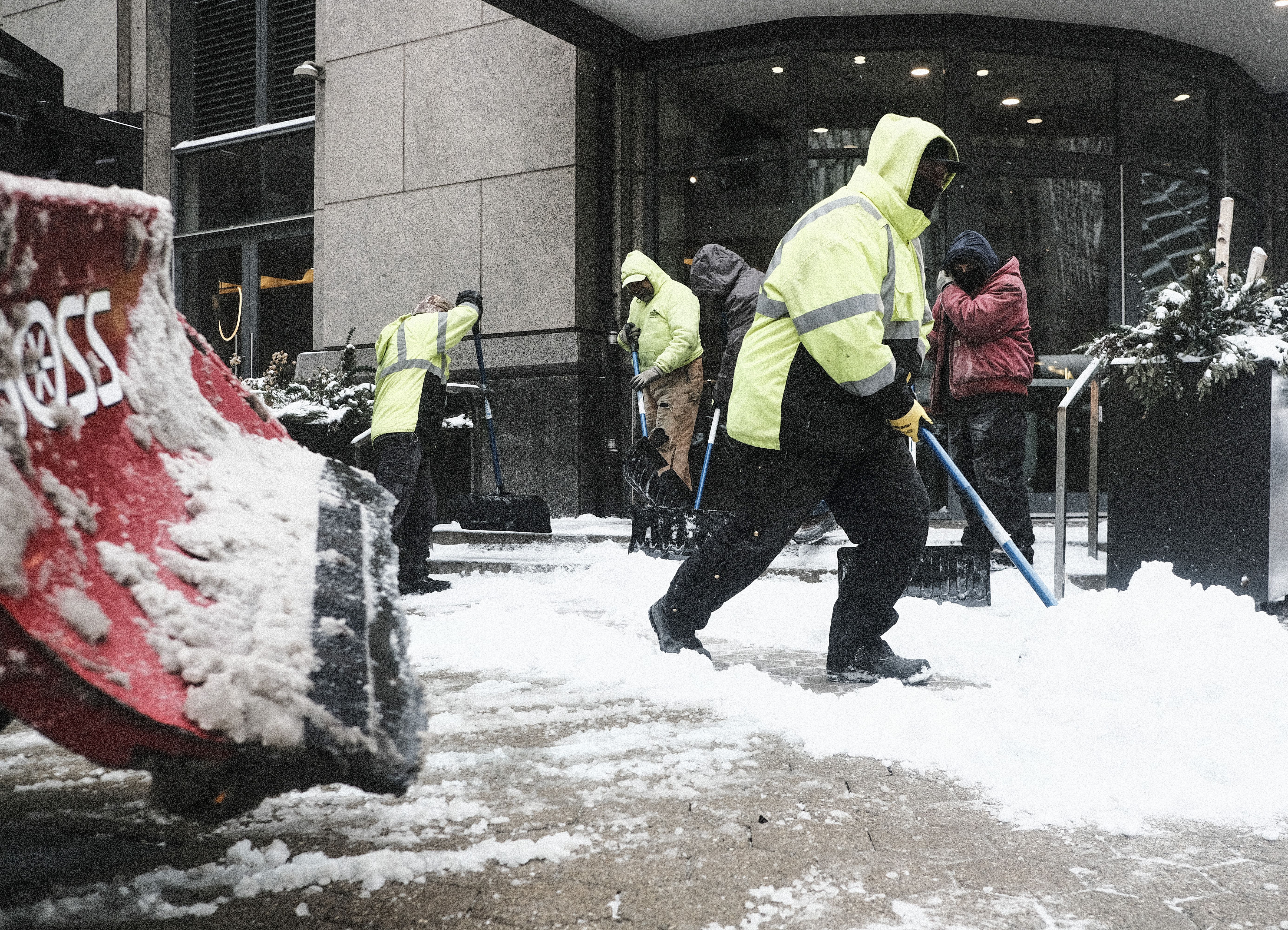 People shoveling snow during a storm in Detroit, Michigan, on Feb. 3.