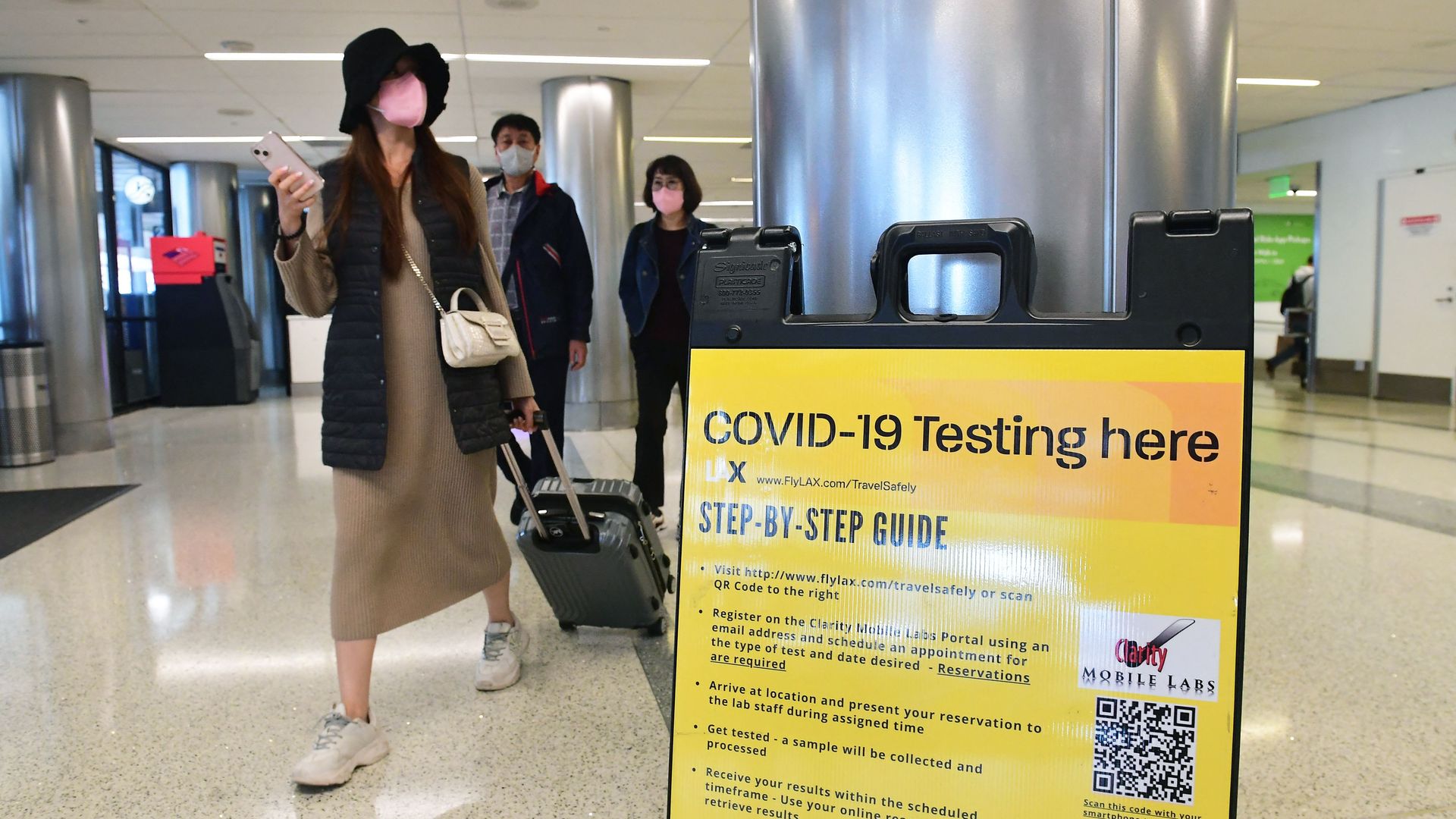 Picture of a yellow sign that says testing is available in this airport