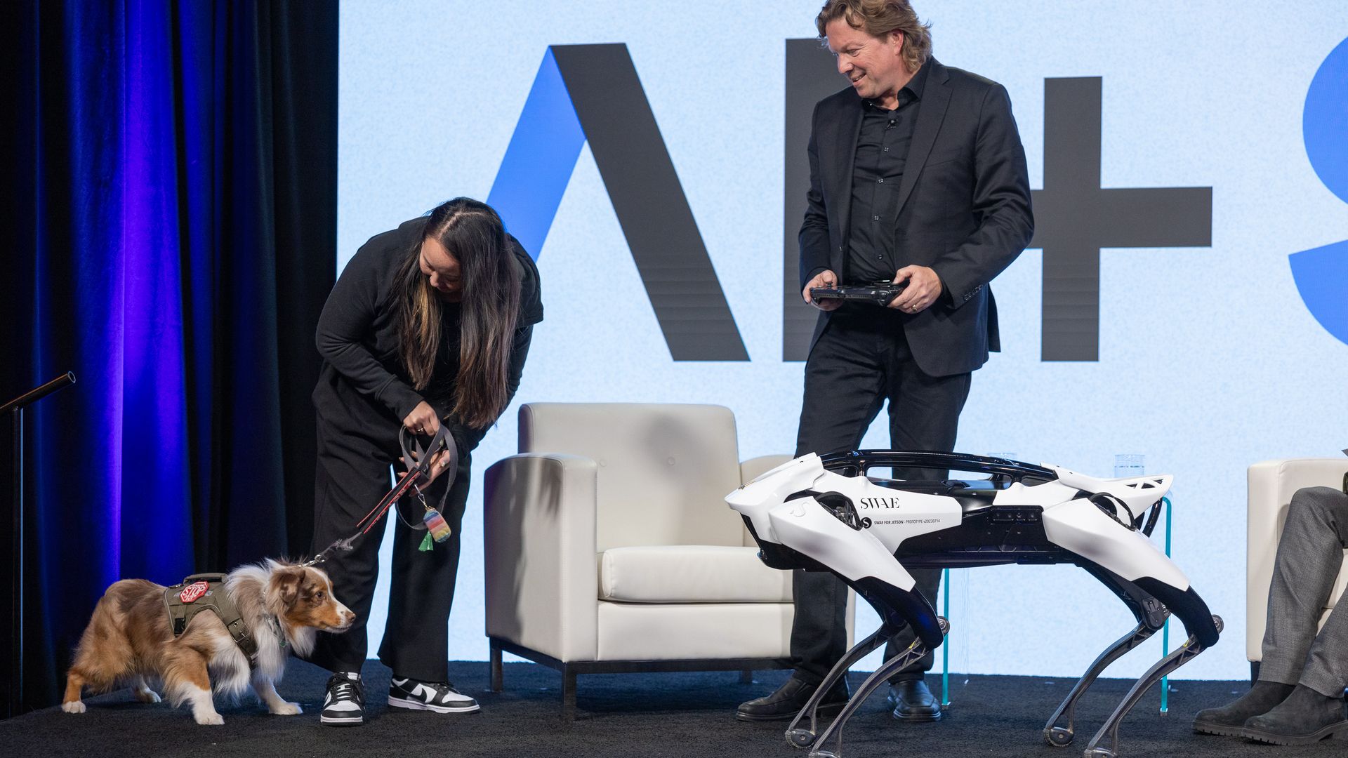 a real dog and a robot dog staring at you