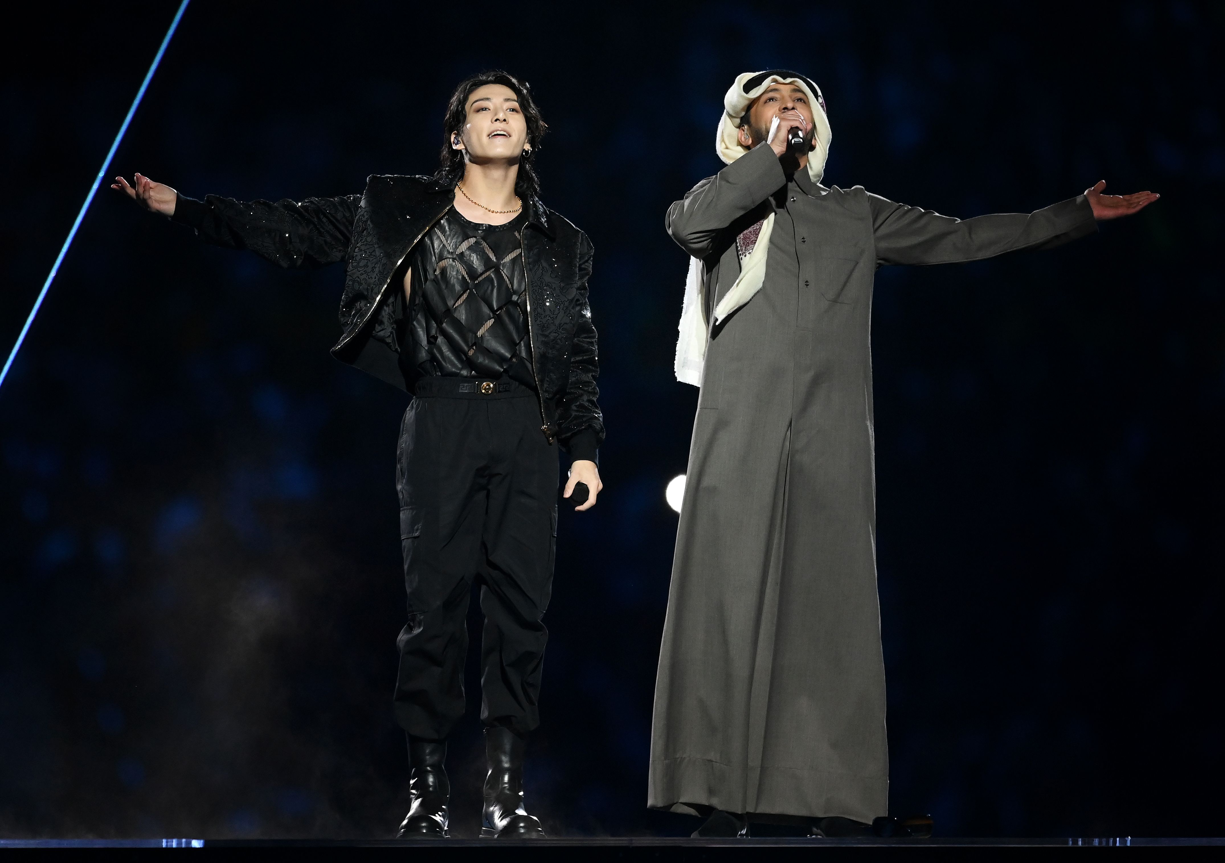 Jung Kook of BTS performs with Fahad Al Kubaisi during the World Cup opening ceremony