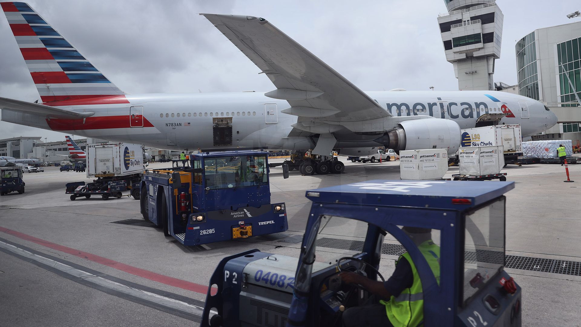  Workers prepare an American Airlines plane at a gate before its flight from the Miami International Airport on June 16, 2021 in Miami, Florida. 