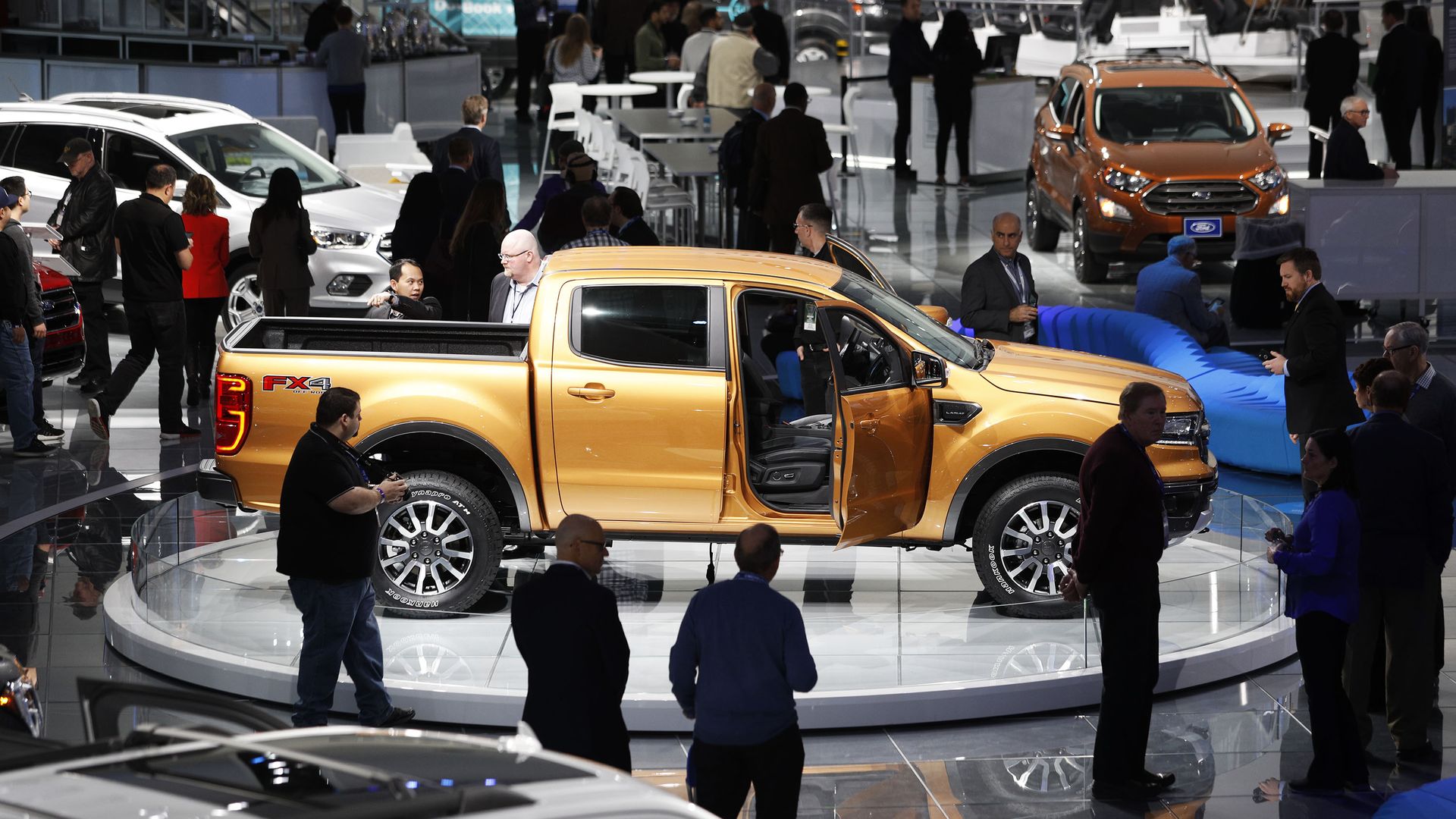 A truck amongst a crowd of people at the Detroit Auto Show