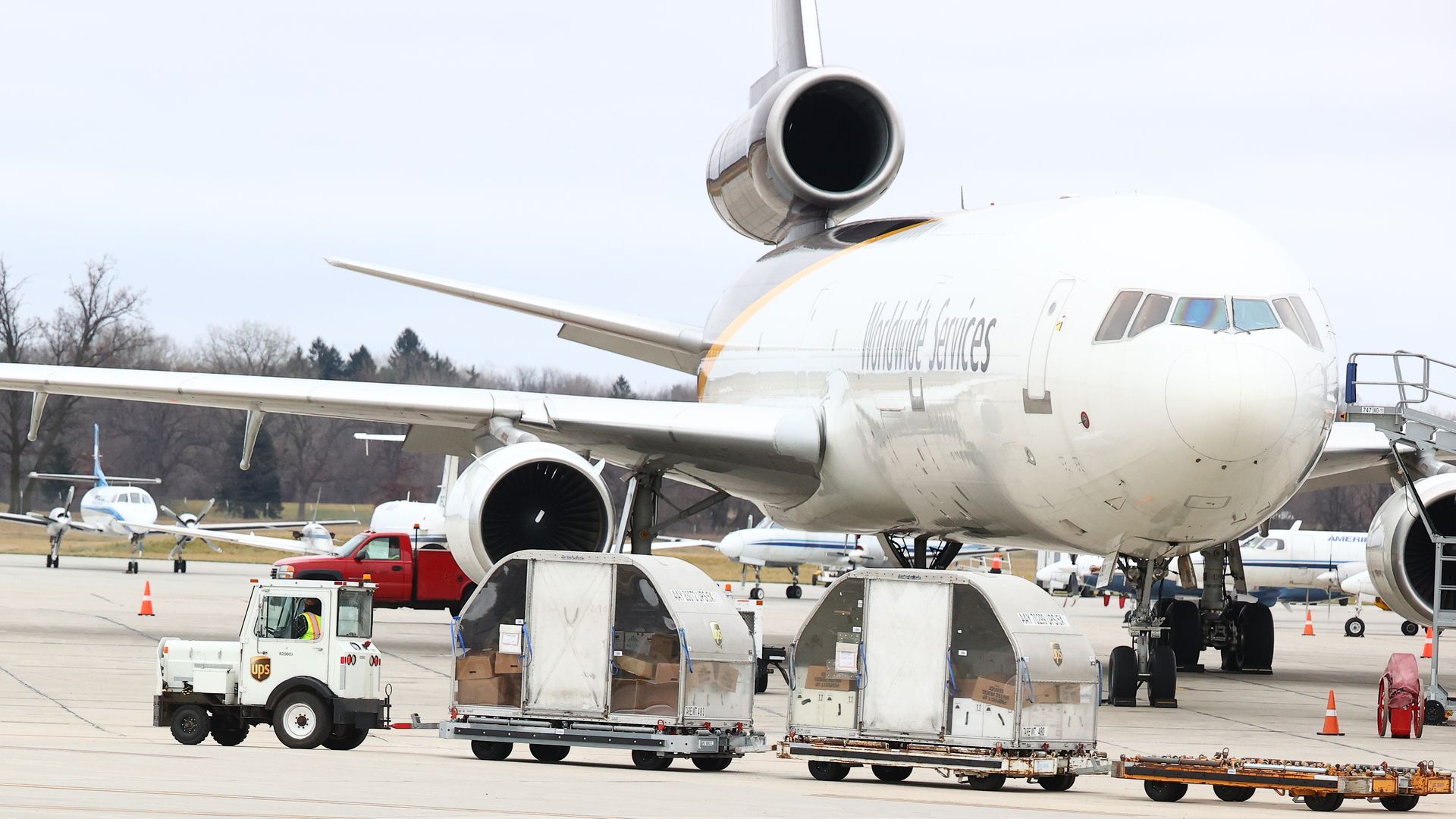 Shipments of the Pfizer And BioNTech COVID-19 vaccine are loaded into a UPS plane at the Capital Region International Airport on December 13, 2020 in Lansing, Michigan.