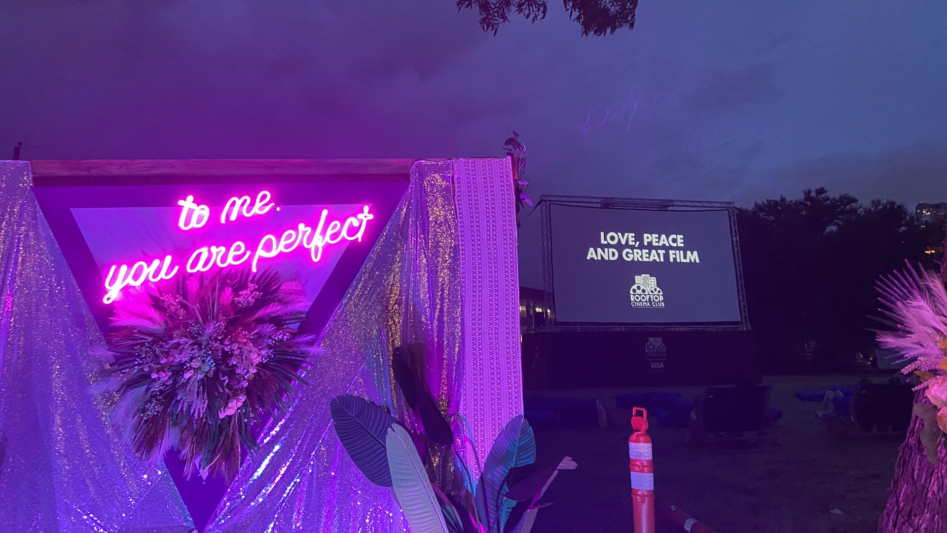 A neon sign that reads "to me you are perfect" against the night sky.