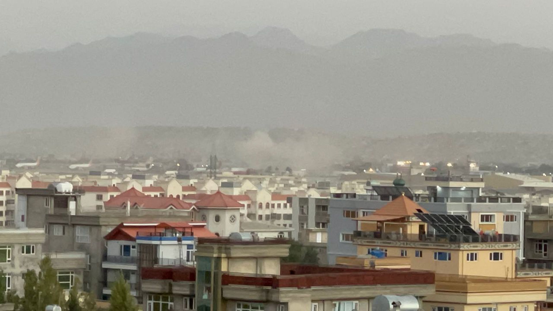 Smoke rises after two explosions reported outside Hamid Karzai International Airport, the