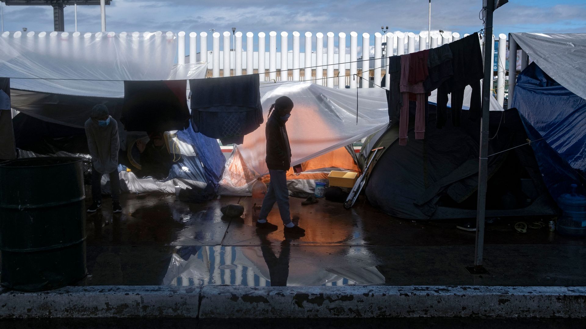 A migrant girl walks at an improvised camp outside El Chaparral crossing port in Tijuana, Baja California state, Mexico, on March 11