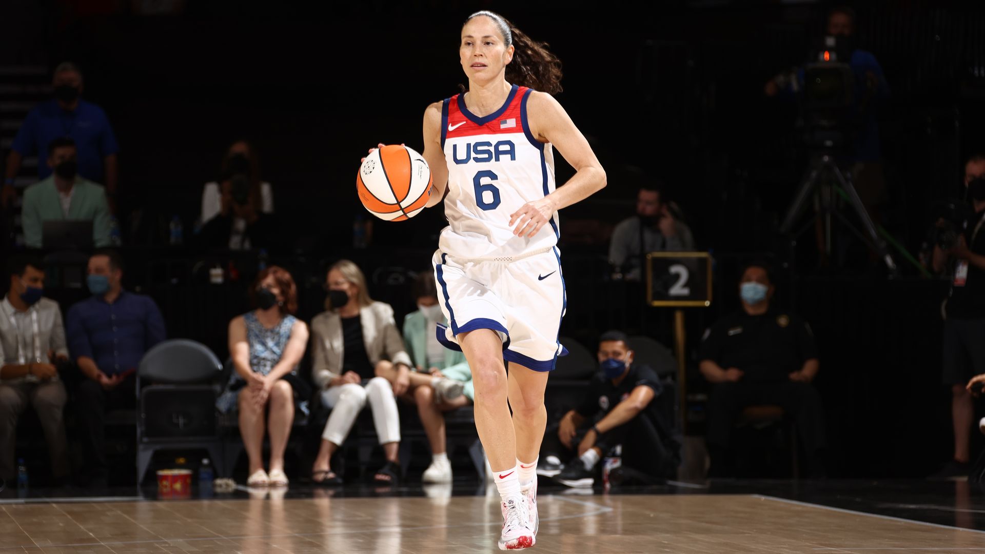 Sue Bird dribbling a basketball.