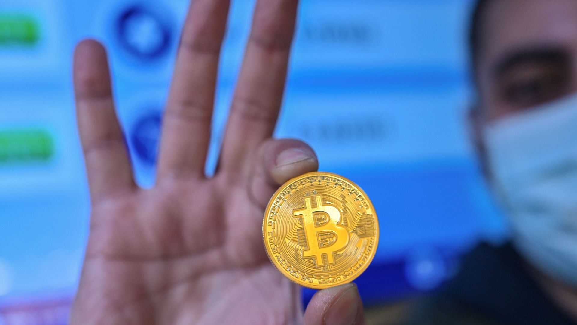 A person holding a physical imitation of a Bitcoinin Istanbul in December 2020.