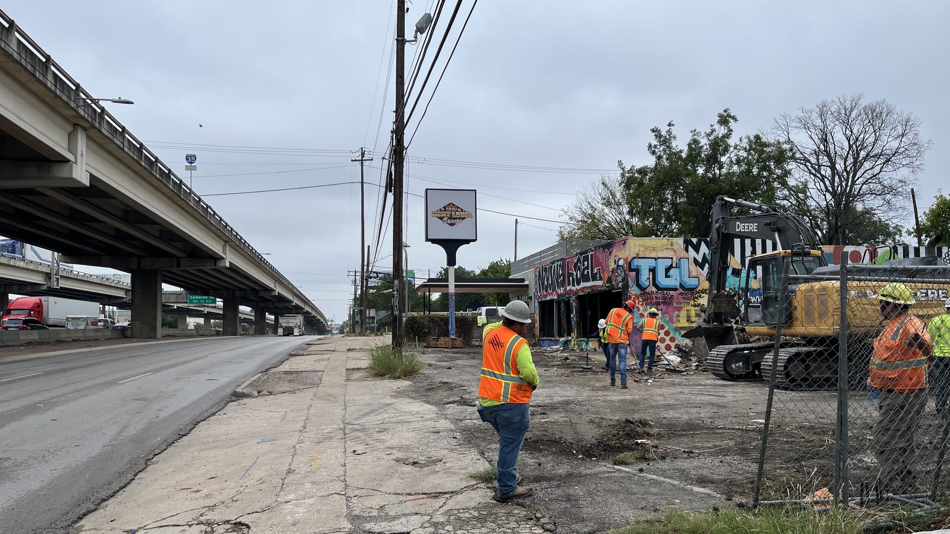 A construction crew beside a highway.