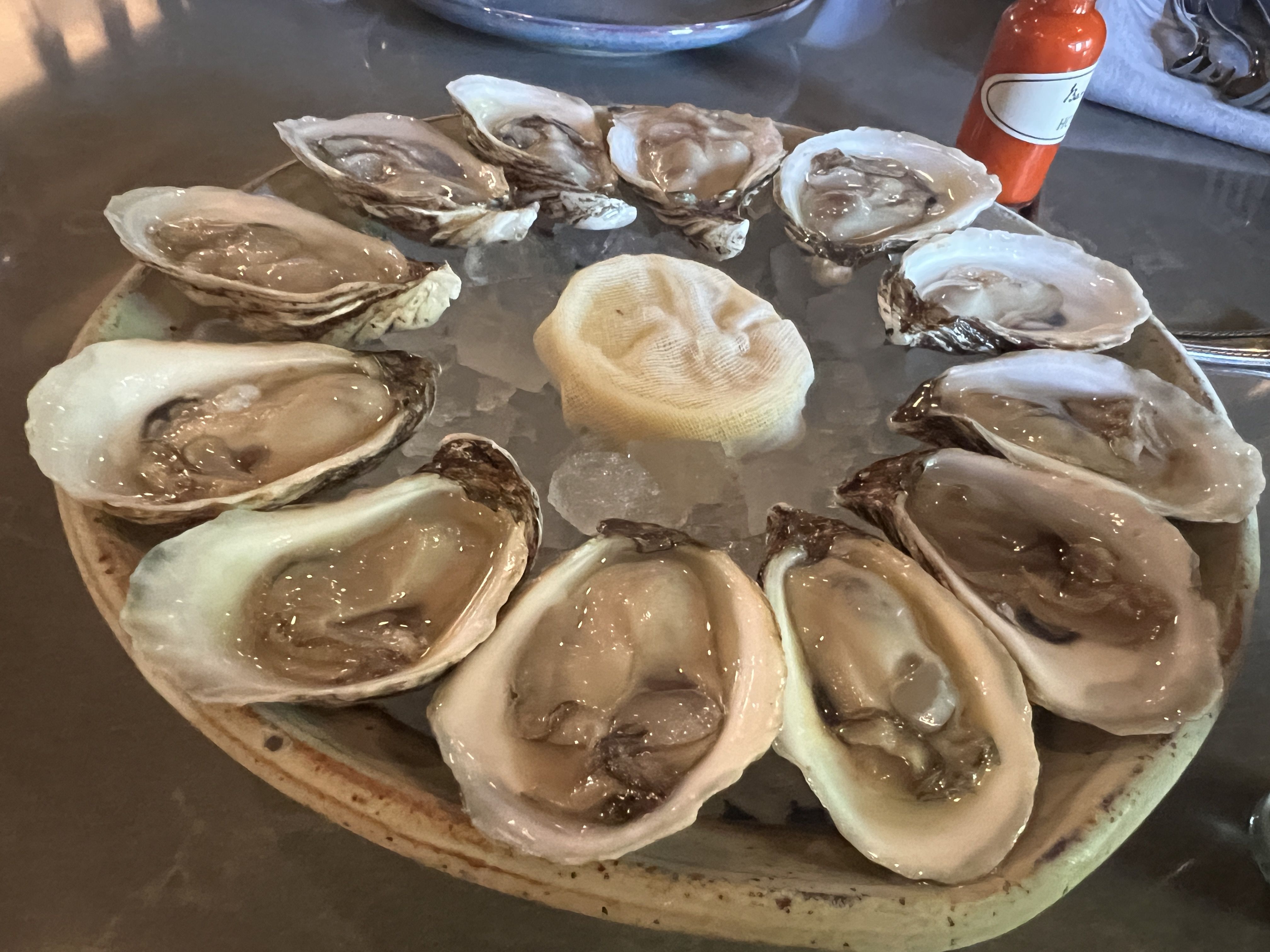 Bar Pigalle's raw oysters are served with a homemade hot sauce and mignonette