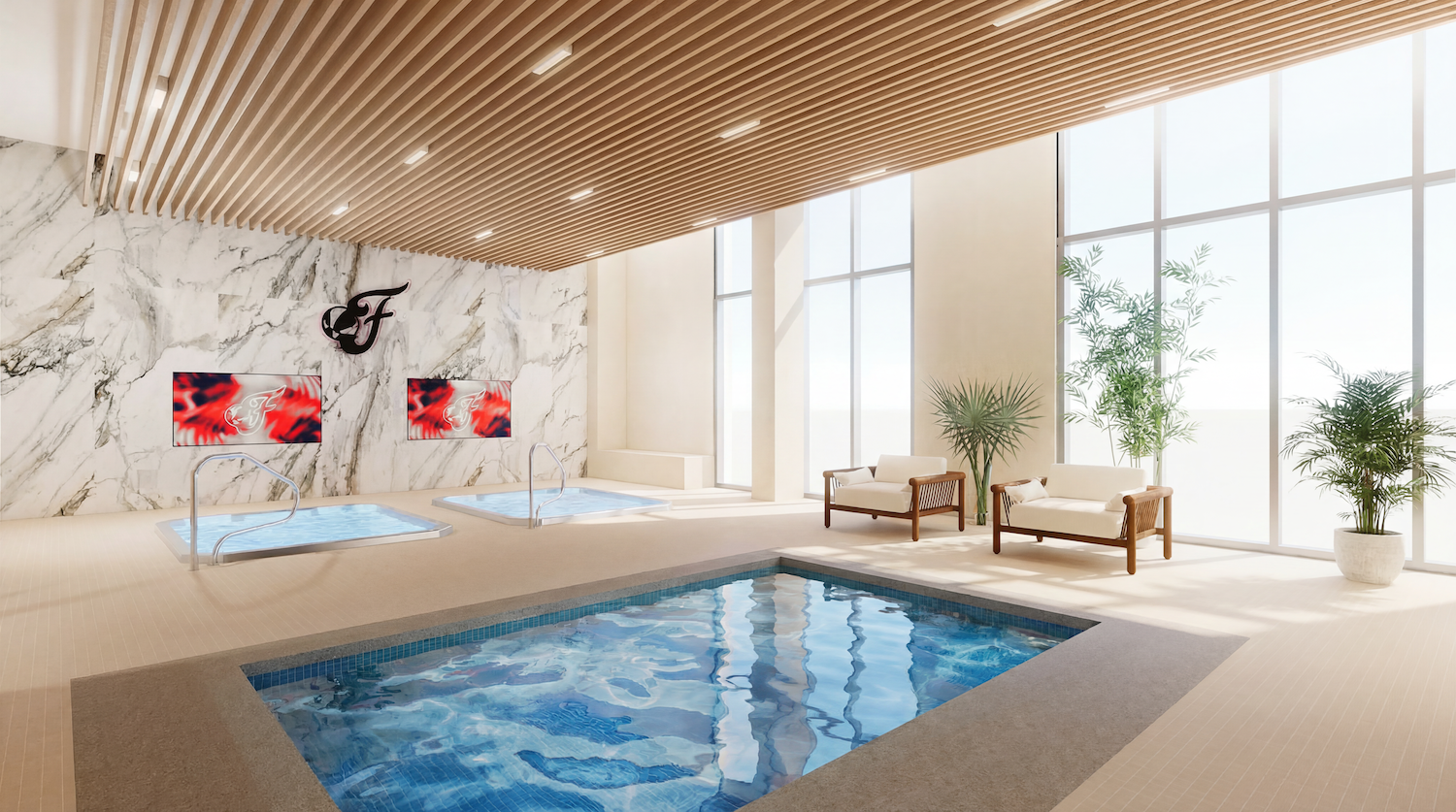 Luxurious indoor spa with a large pool, two marble-wall hot tubs, a black F logo and two red art panels, wooden slat ceiling, tall glass windows, beige tile floor, cushioned seating with plants.