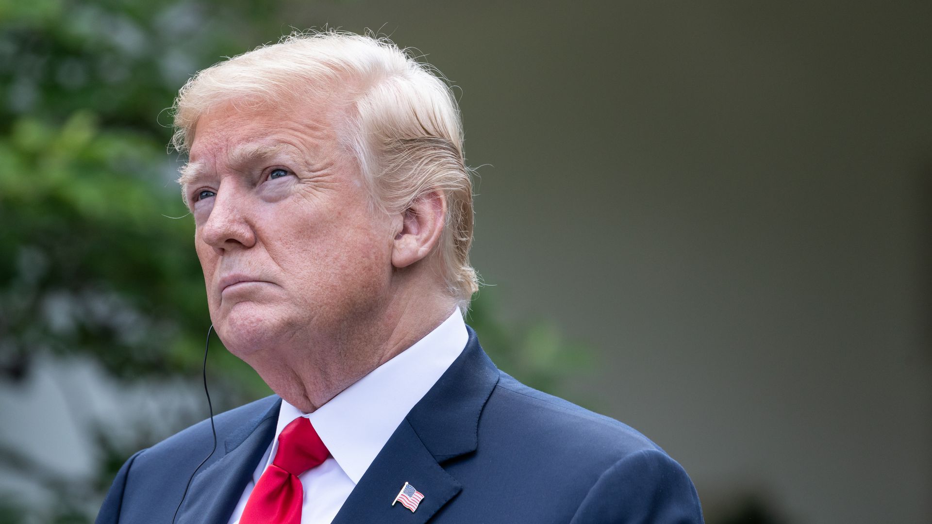 U.S. President Donald Trump looks toward the sky during a press conference 