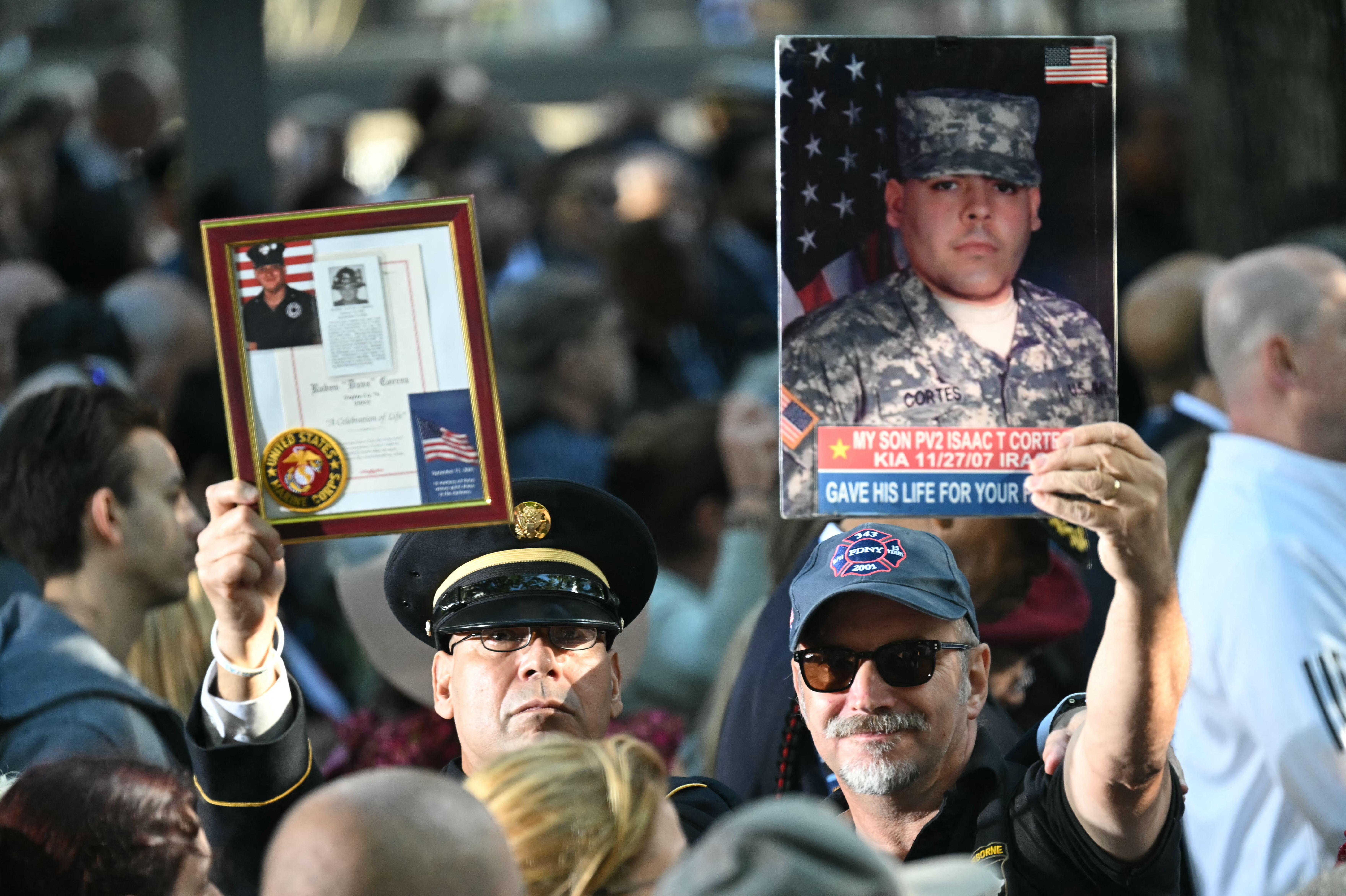 People attend a remembrance ceremony on the 23rd anniversary of the September 11 terror attack 