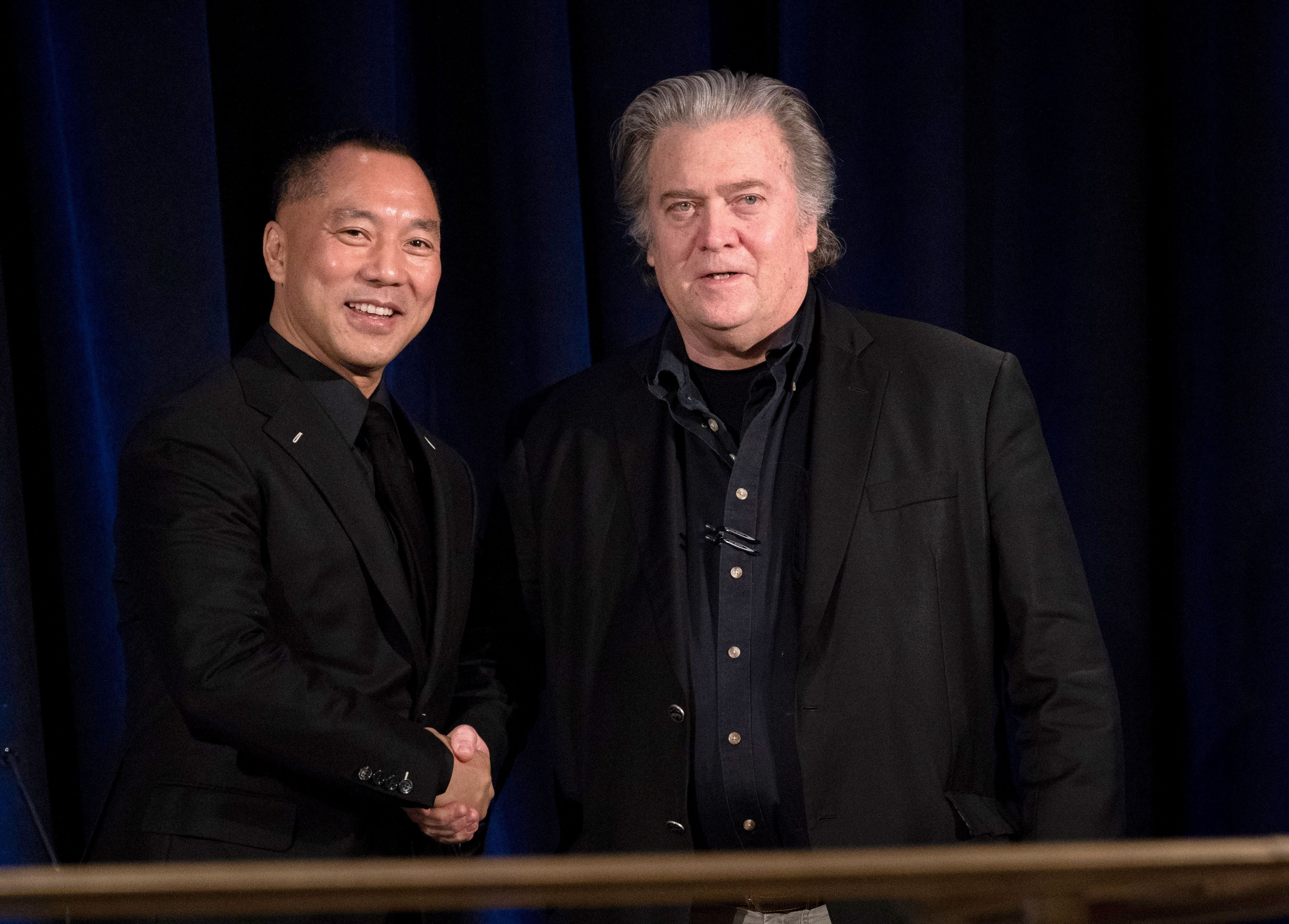 Former White House Chief Strategist Steve Bannon (R) greets fugitive Chinese billionaire Guo Wengui before introducing him at a news conference on November 20, 2018 in New York, on the death of of tycoon Wang Jian in France on July 3, 2018.