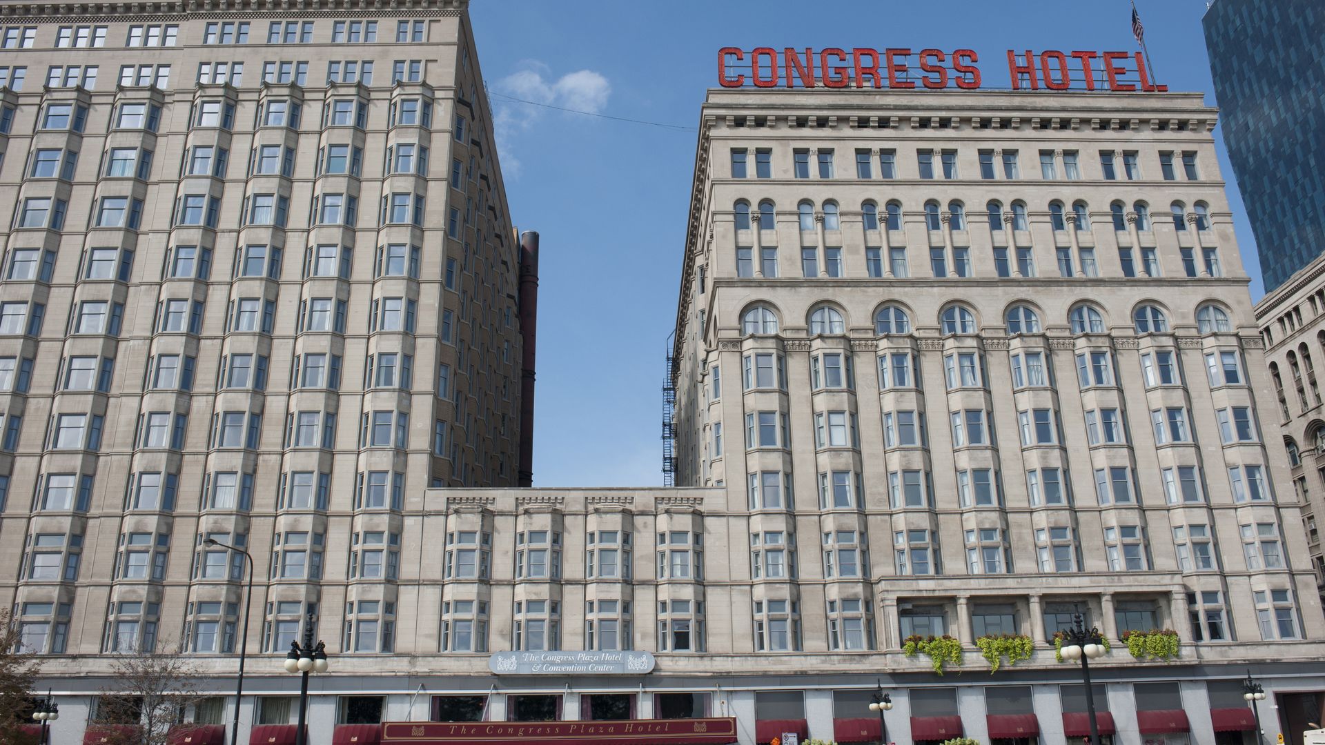 A hotel with a sign saying "Congress Hotel" on the top. 