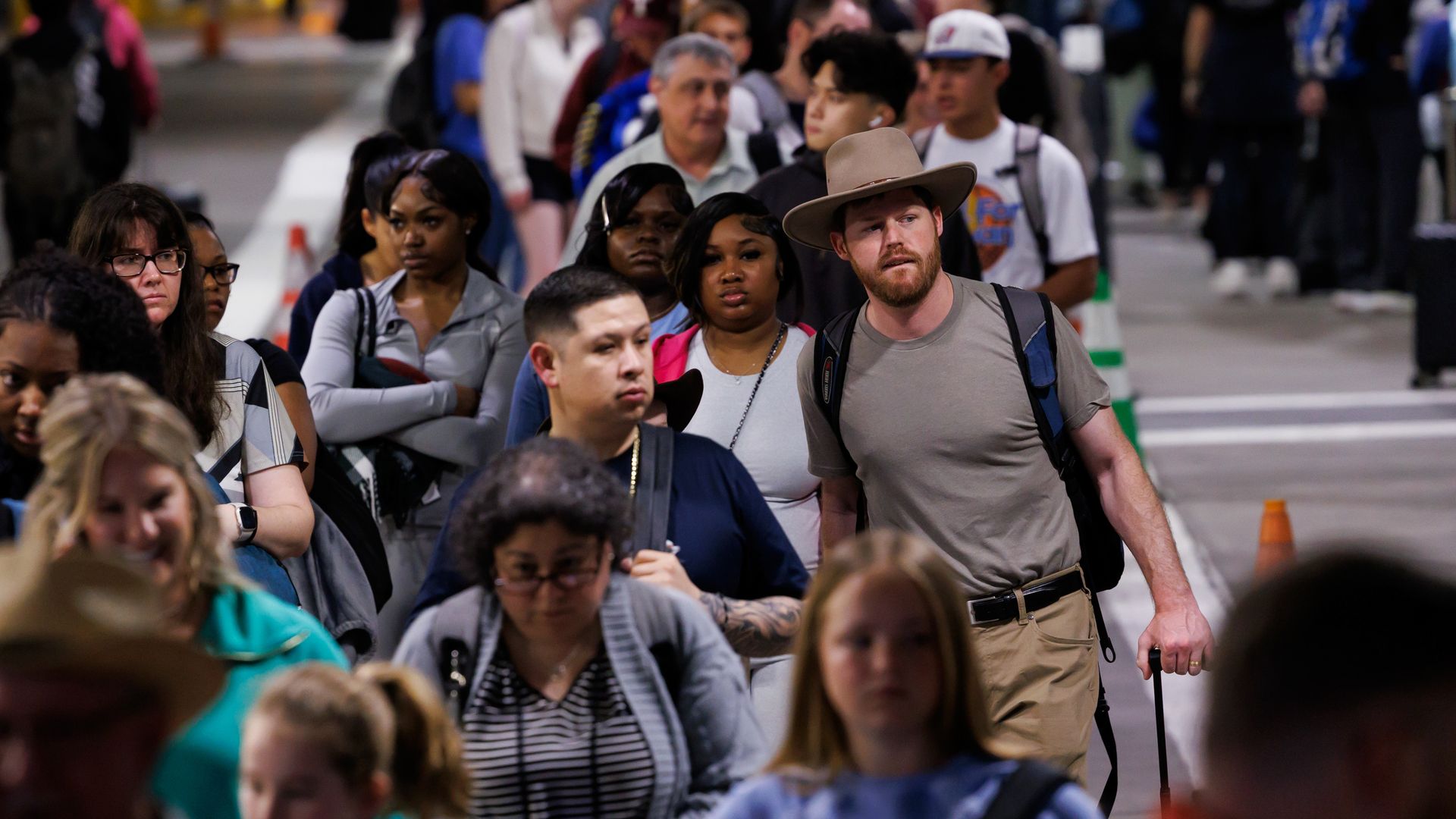 People wait in line at Hobby Airport