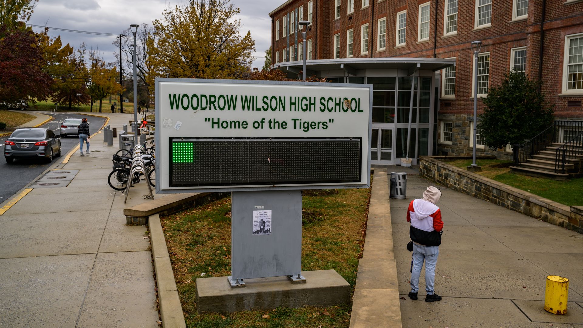 A sign of Woodrow Wilson High School outside its building.