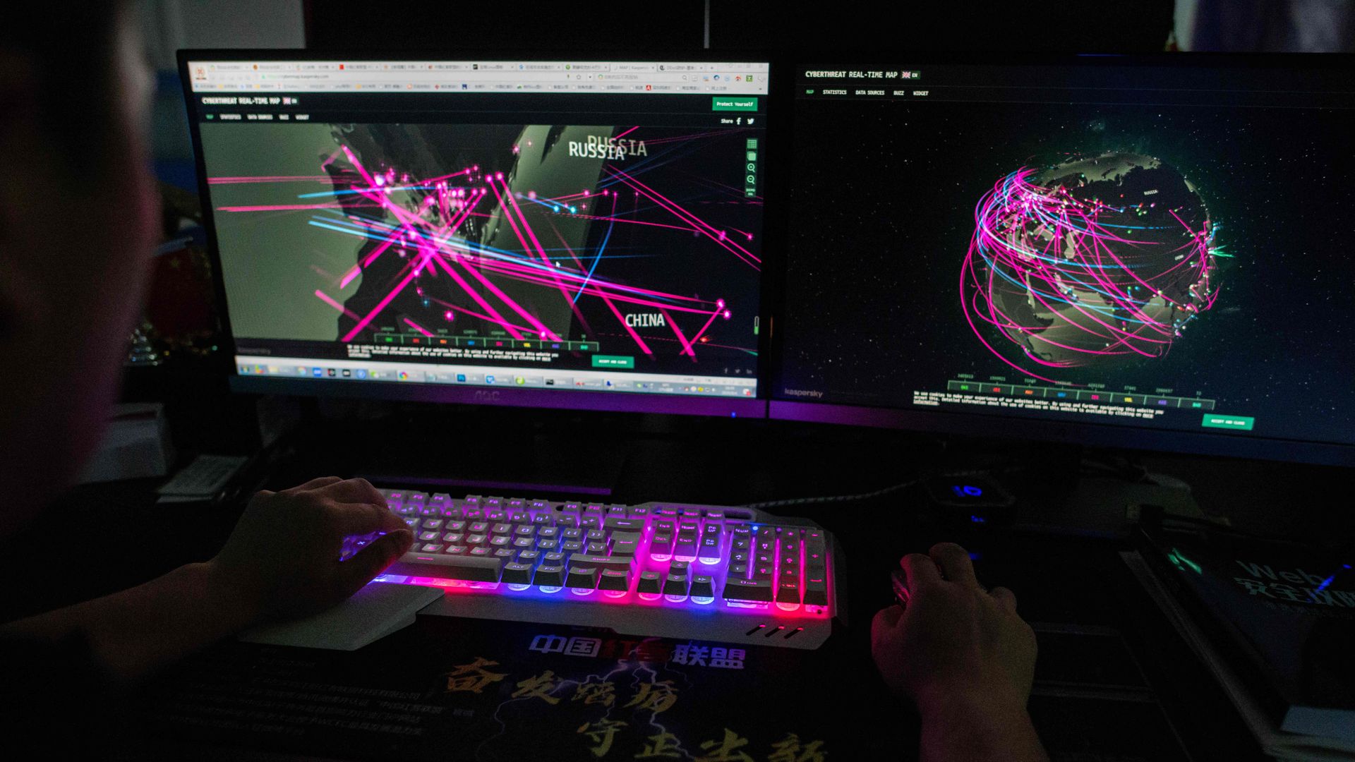   In this file photo taken on August 4, 2020, a member of the Red Hacker Alliance monitors global cyberattacks on his computer at their office in Dongguan, China's southern Guangdong province. 