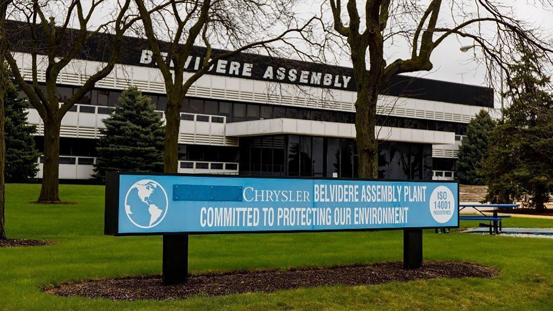 A blue sign with white lettering. It shows the Fiat Chrysler plant in Belvidere, Illinois.