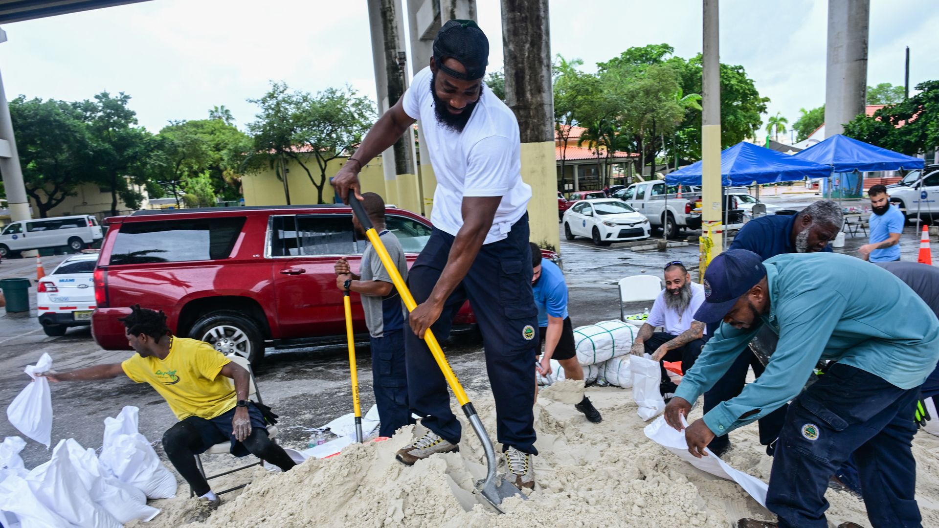 Volunteers from the city of Miami fill sandbags to help residents prepare for the arrival of Hurricane Milton in Miami, Florida on October 7, 2024. Florida's governor has declared a state of emergency on Saturday as forecasters warned that Hurricane Milton is expected to make landfall later this wee