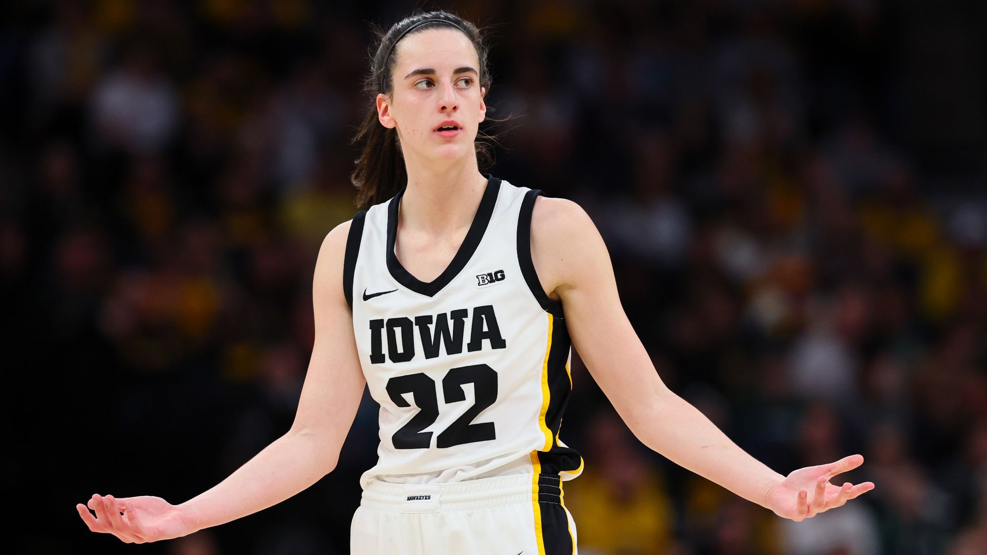 Caitlin Clark with her arms out