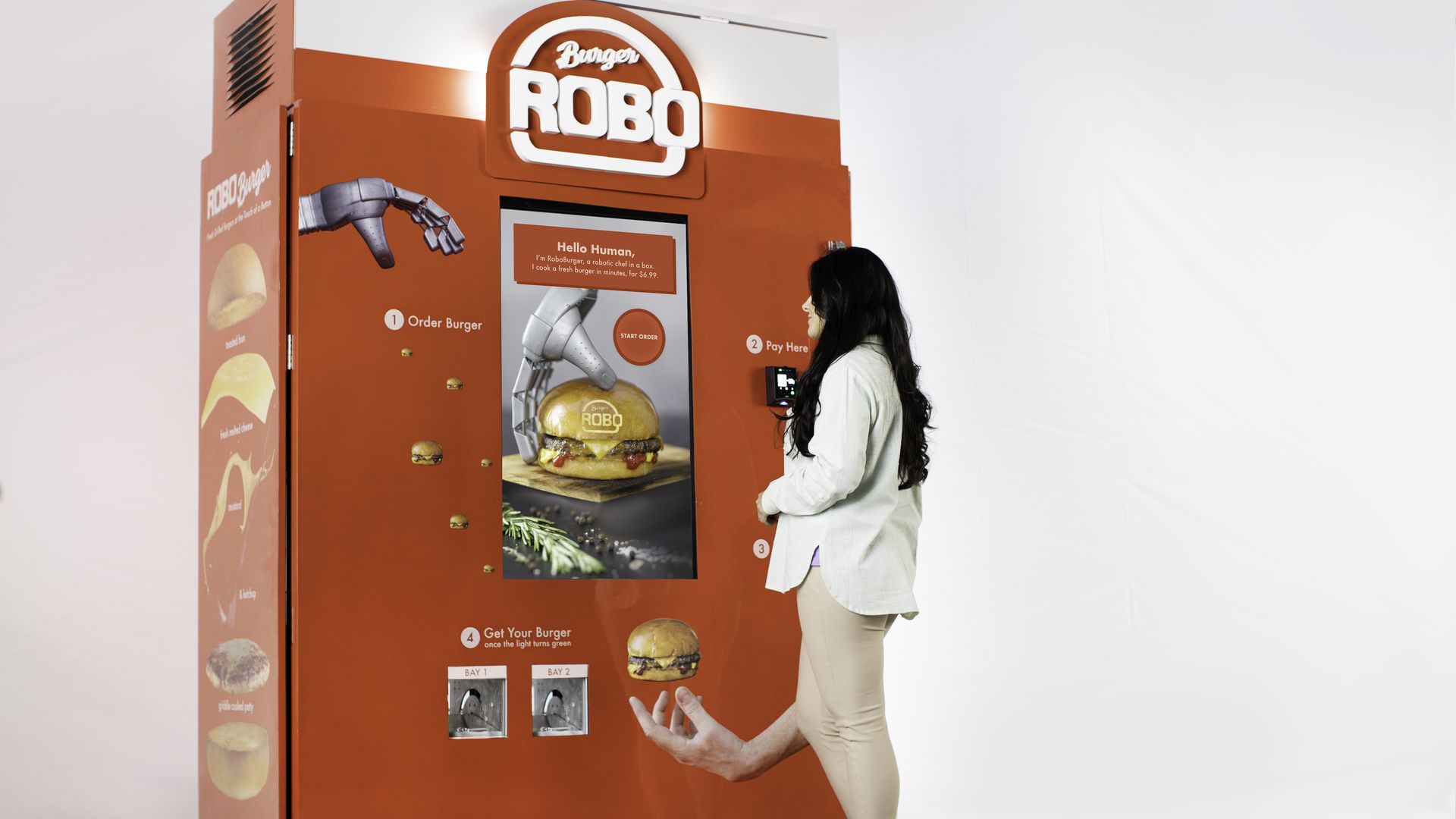 A woman stands in front of a hamburger vending machine