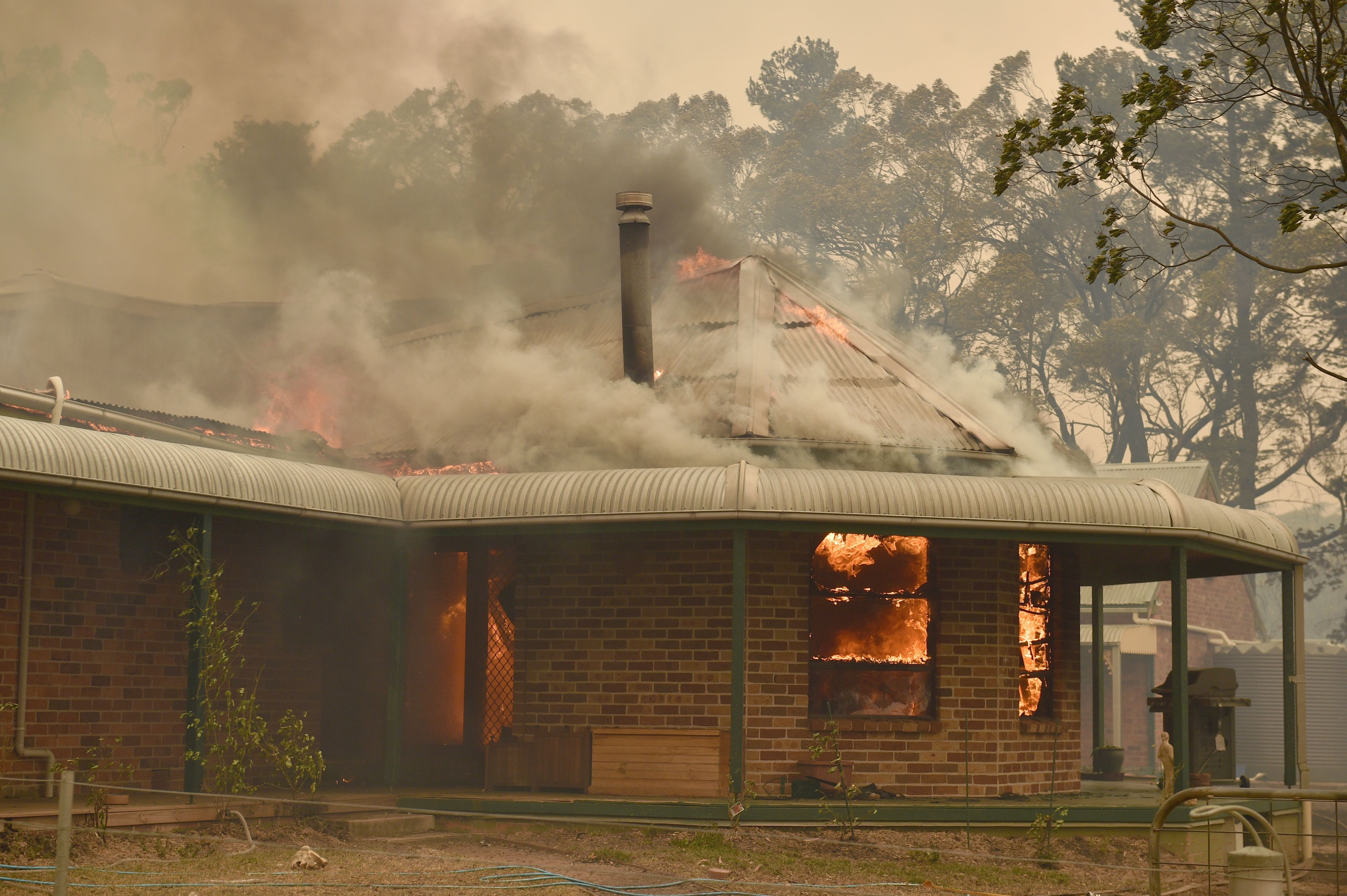 Fire engulfs a property in Balmoral, southwest of Sydney. 