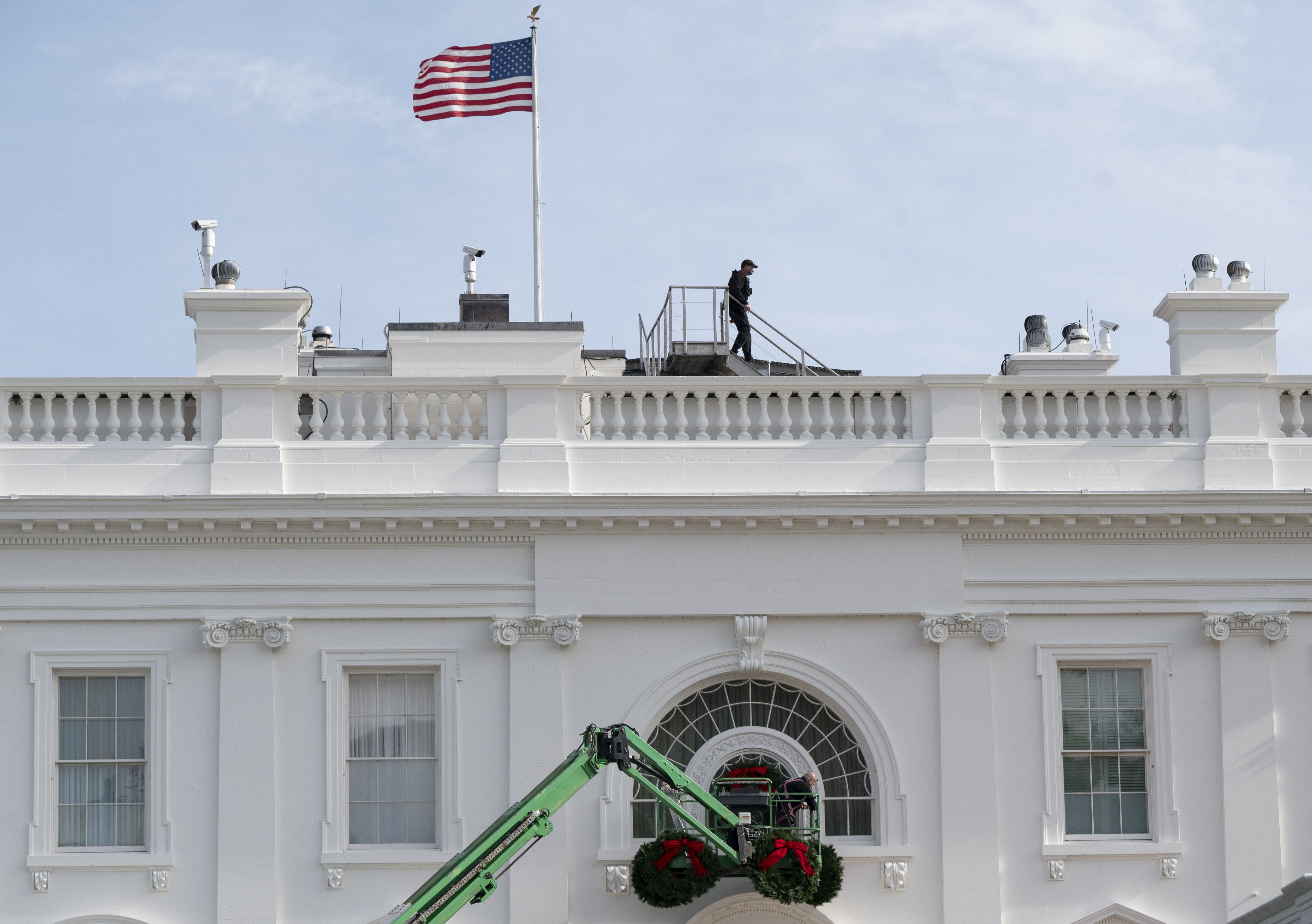 Christmas wreaths are installed at the White House 