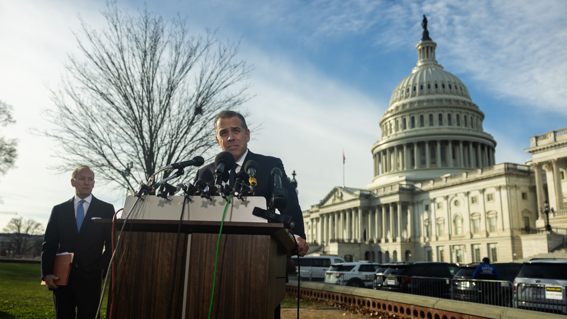 Hunter Biden speaks behind a microphone with the U.S. Capitol in the background.