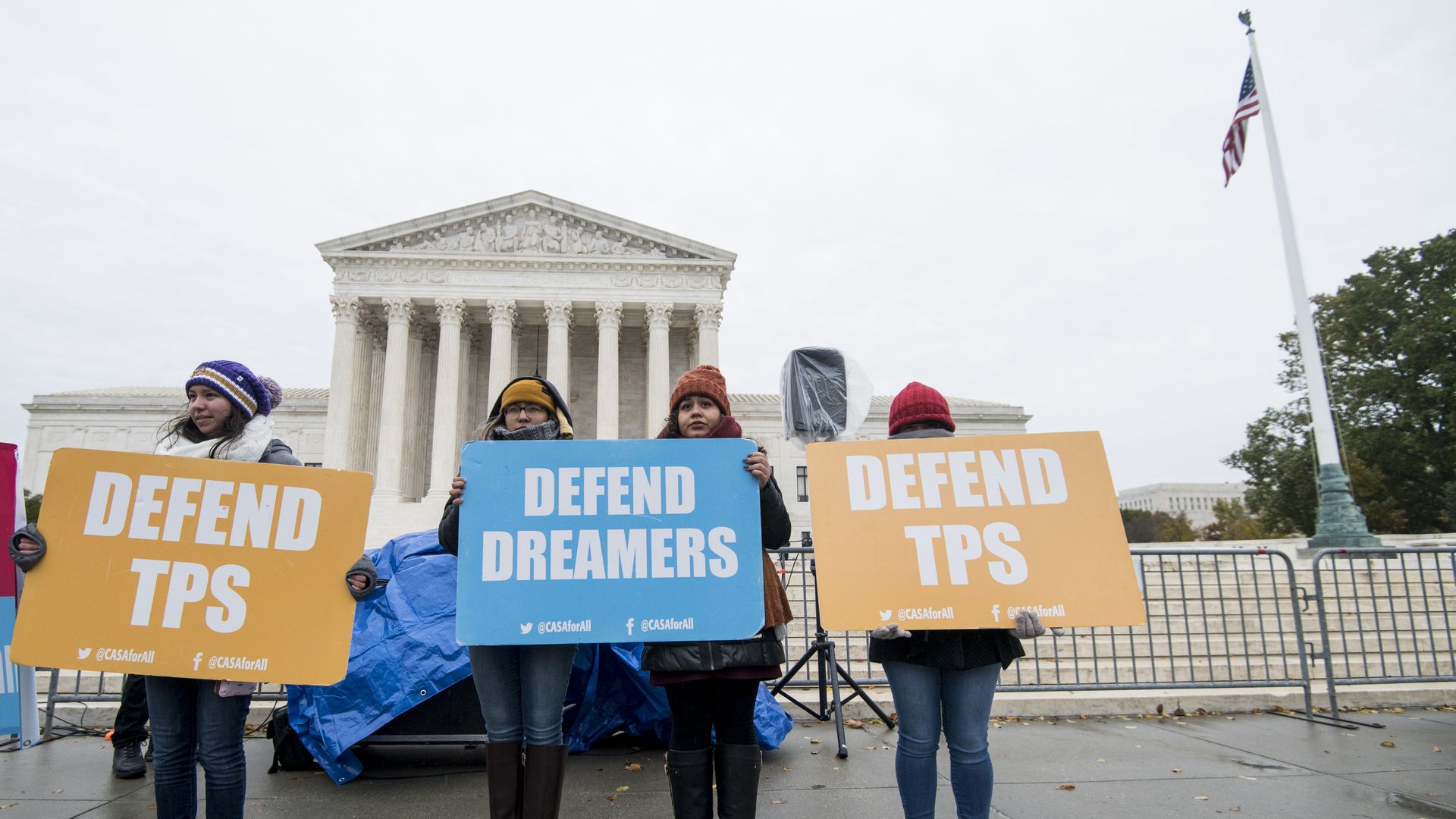 Protesters hold signs supporting dreamers and TPS outside of the U.S. Supreme Court on Tuesday, Nov. 12, 2019.