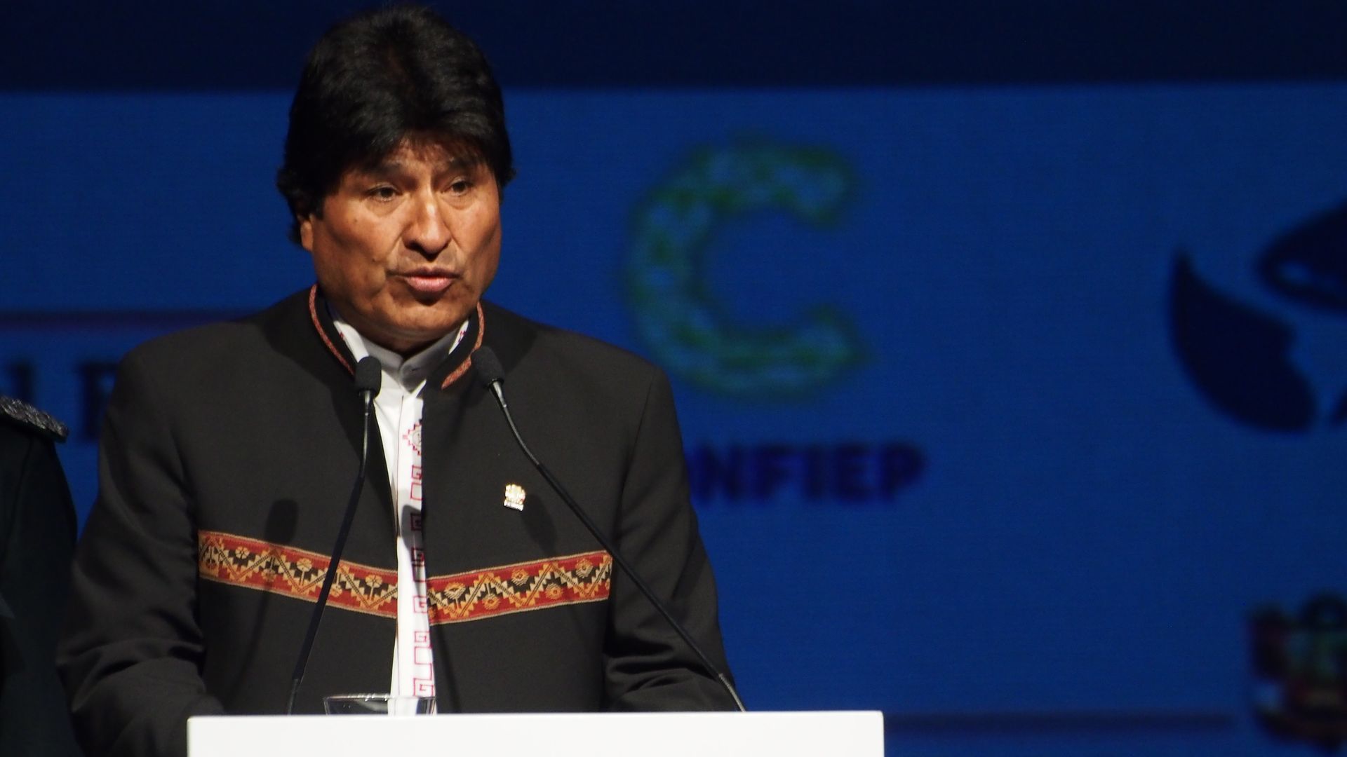 Evo Morales speaking at a lectern